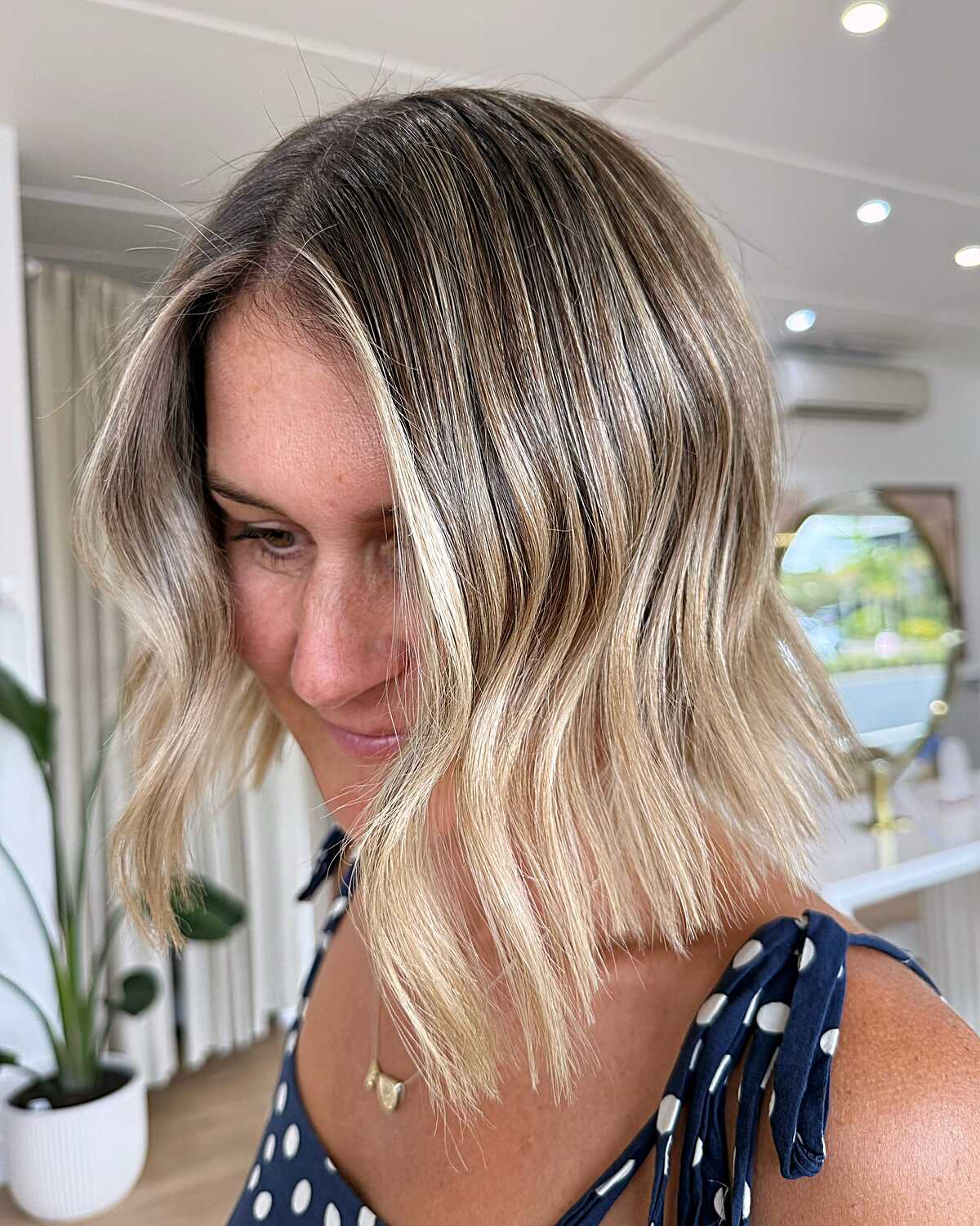 Balayage bob with dark roots and blonde wavy ends