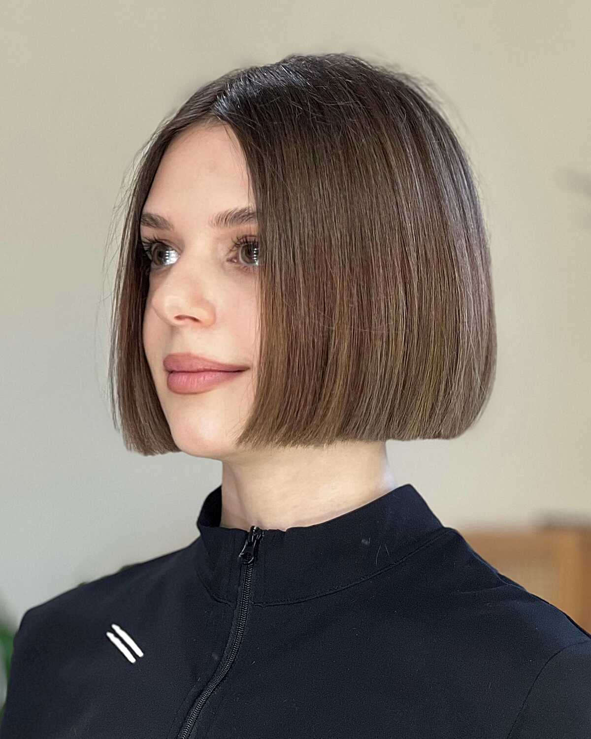 Chin-length mousy brown blunt bob with subtle layers