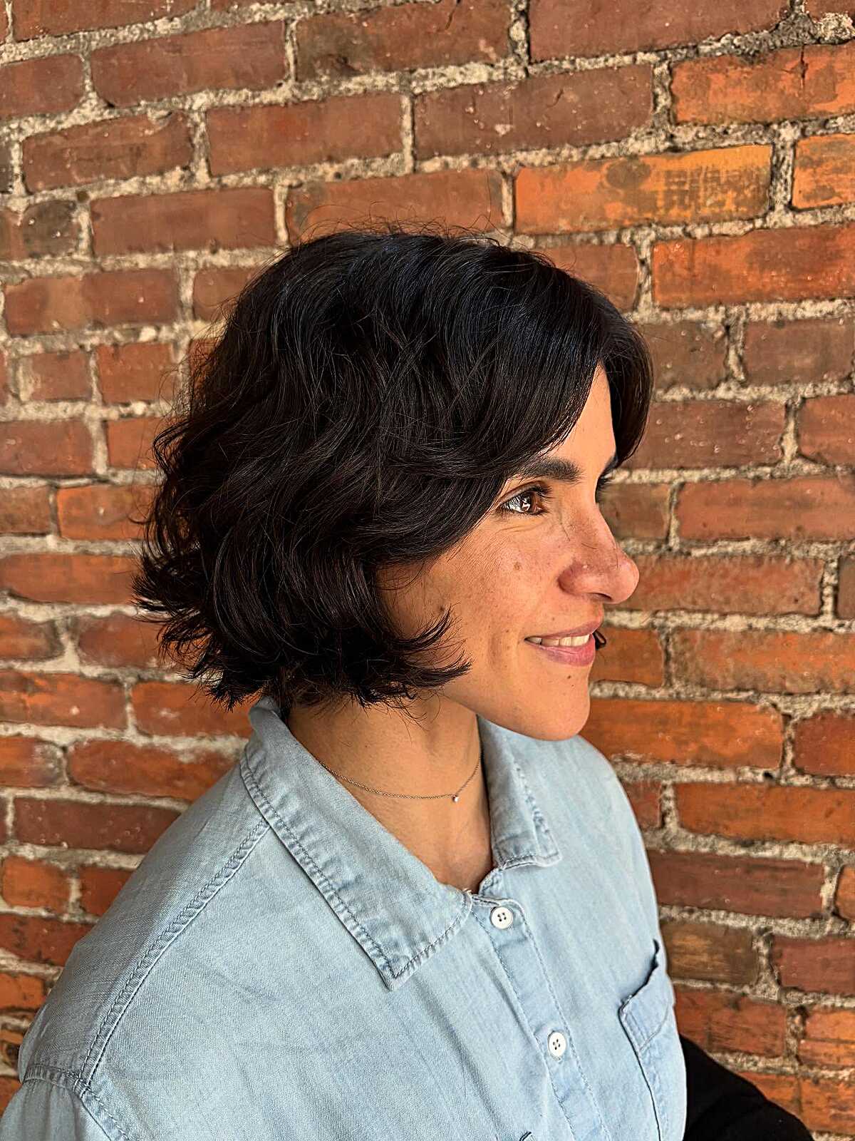 Dark espresso wavy blunt bob on naturally curly hair