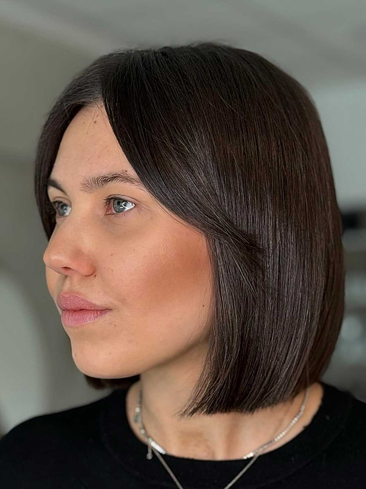 Dark espresso chin-length blunt bob with side part