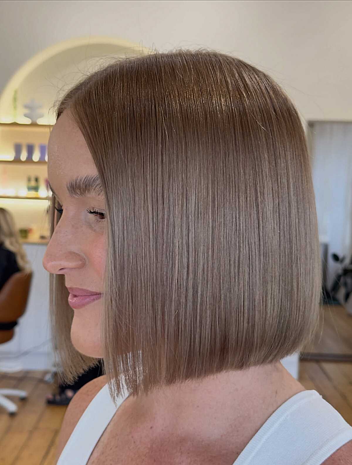 Sleek ash brunette blunt bob with glass-like shine