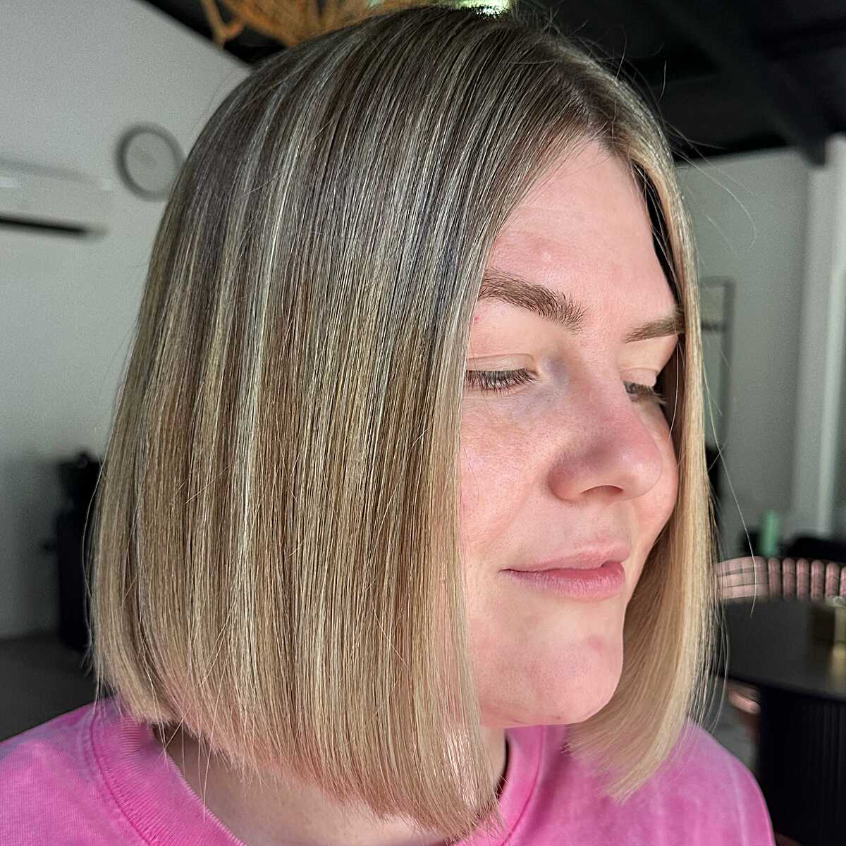 Straight jaw-length bob with subtle blonde highlights