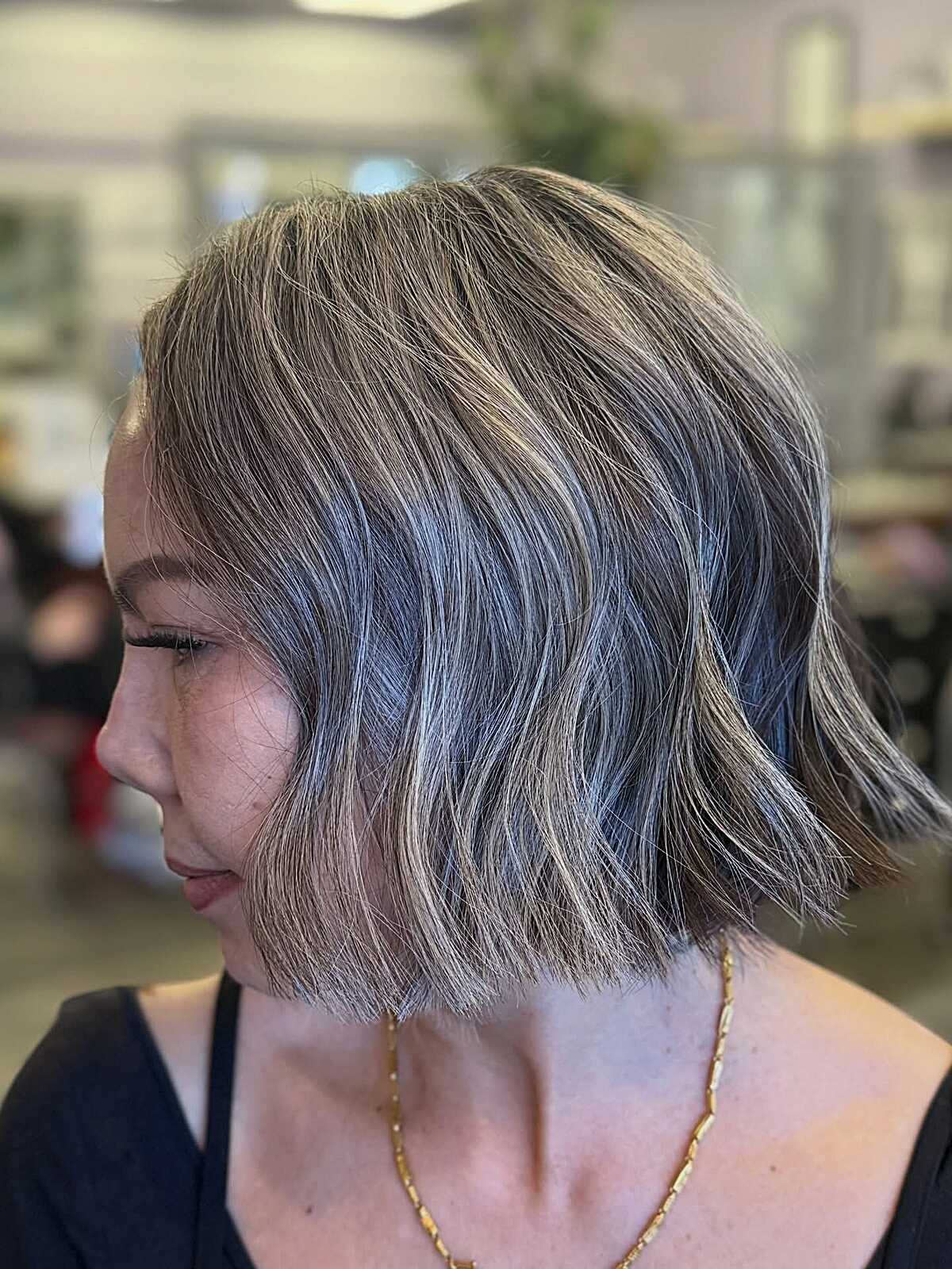 Wavy ash bob with natural gray blending throughout
