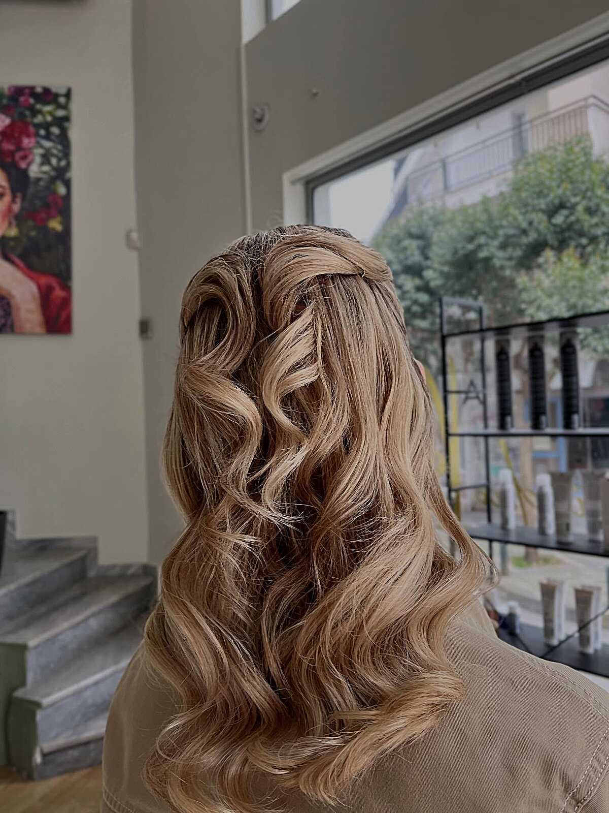 Honey blonde half up with minimal twist and waves