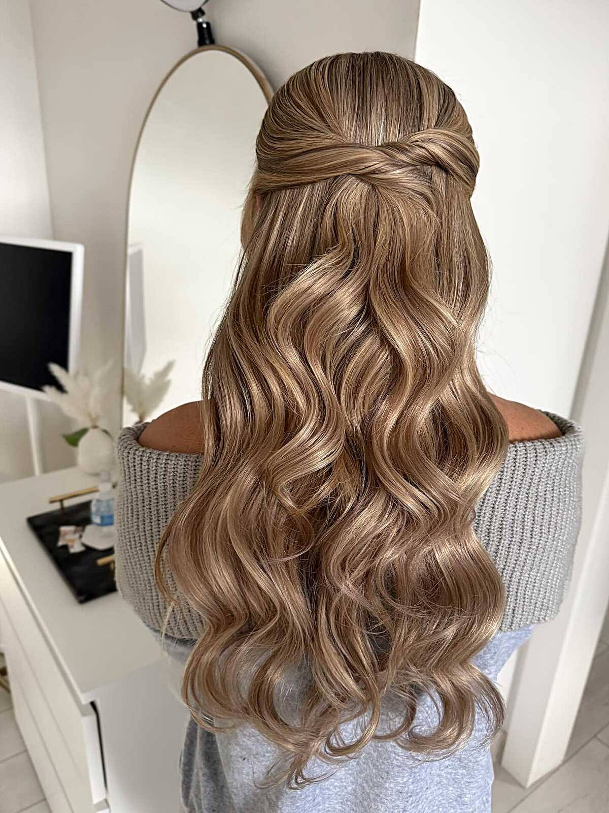 Honey blonde half up with twisted back and waves