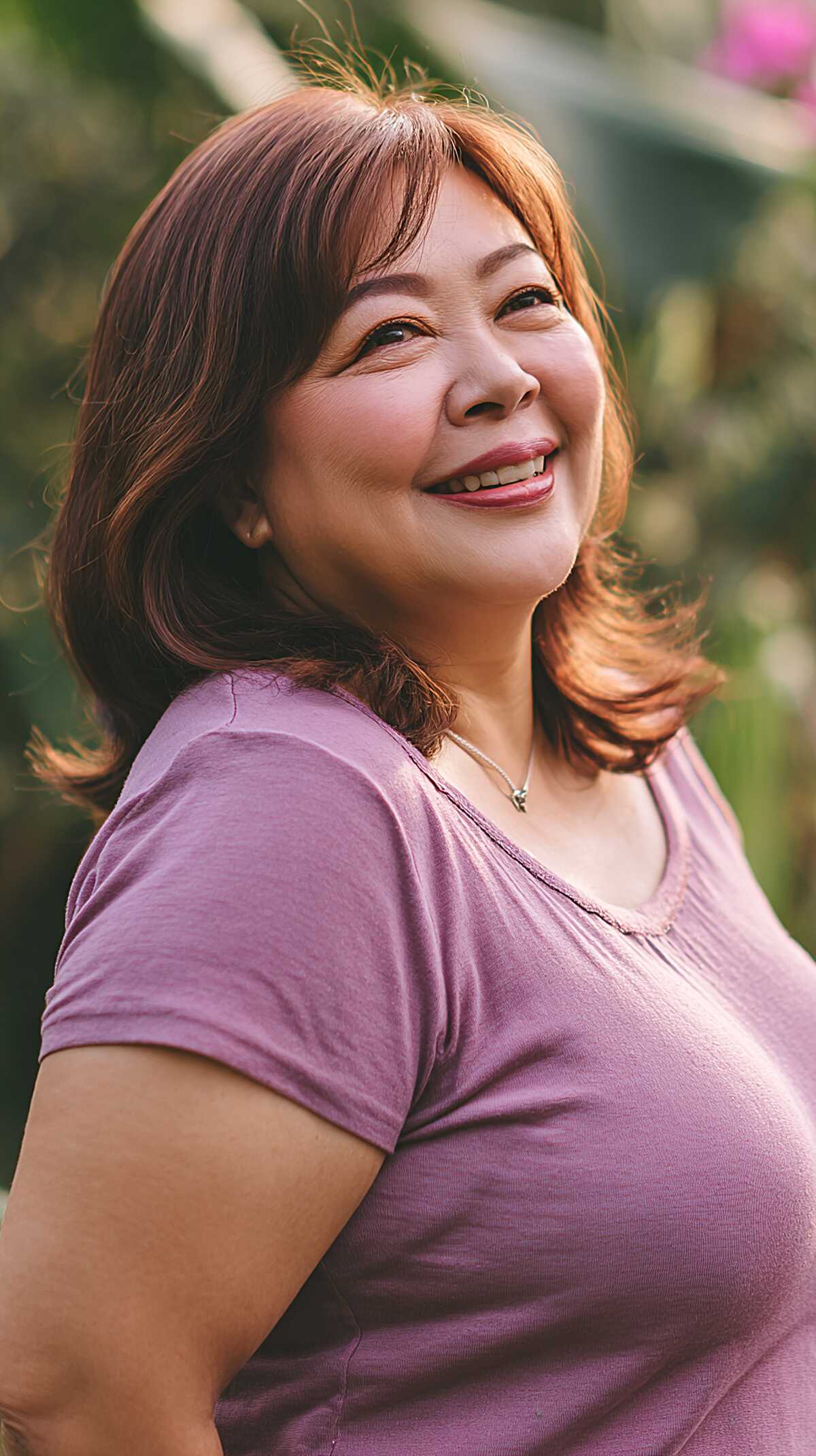 Auburn-tipped layered bob with side bangs and flipped ends