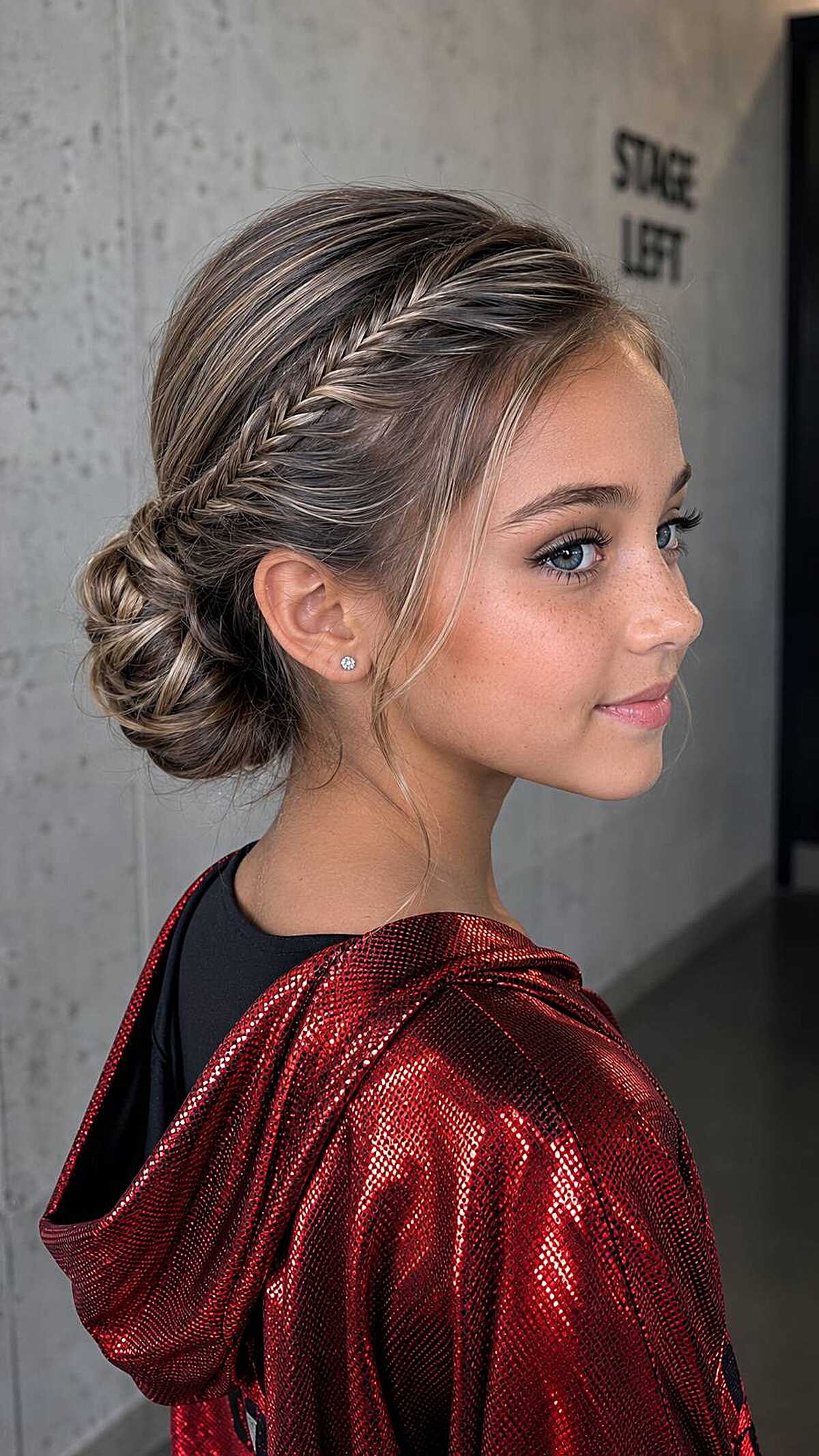 Girl with fishtail braid accent into a low textured bun