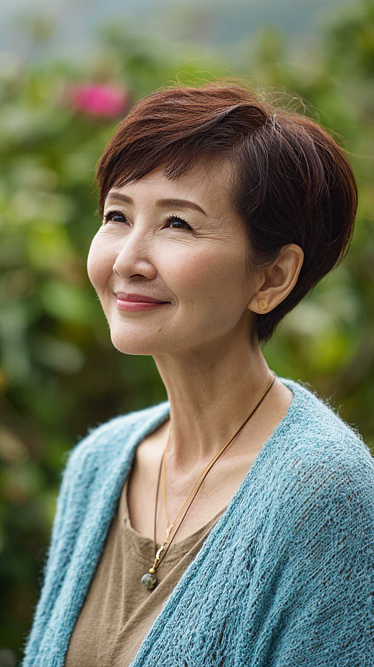 Polished auburn long pixie with side-swept volume