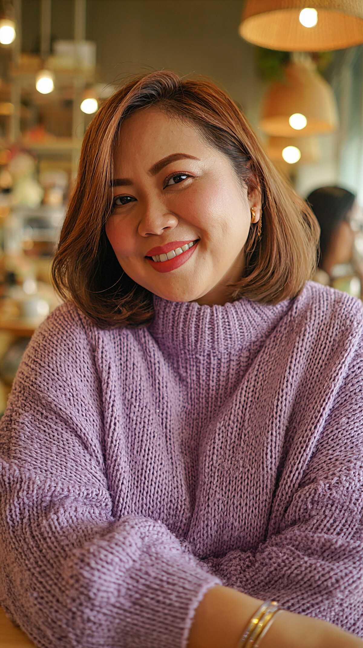 Sleek warm brown bob with inward-curled ends and side part