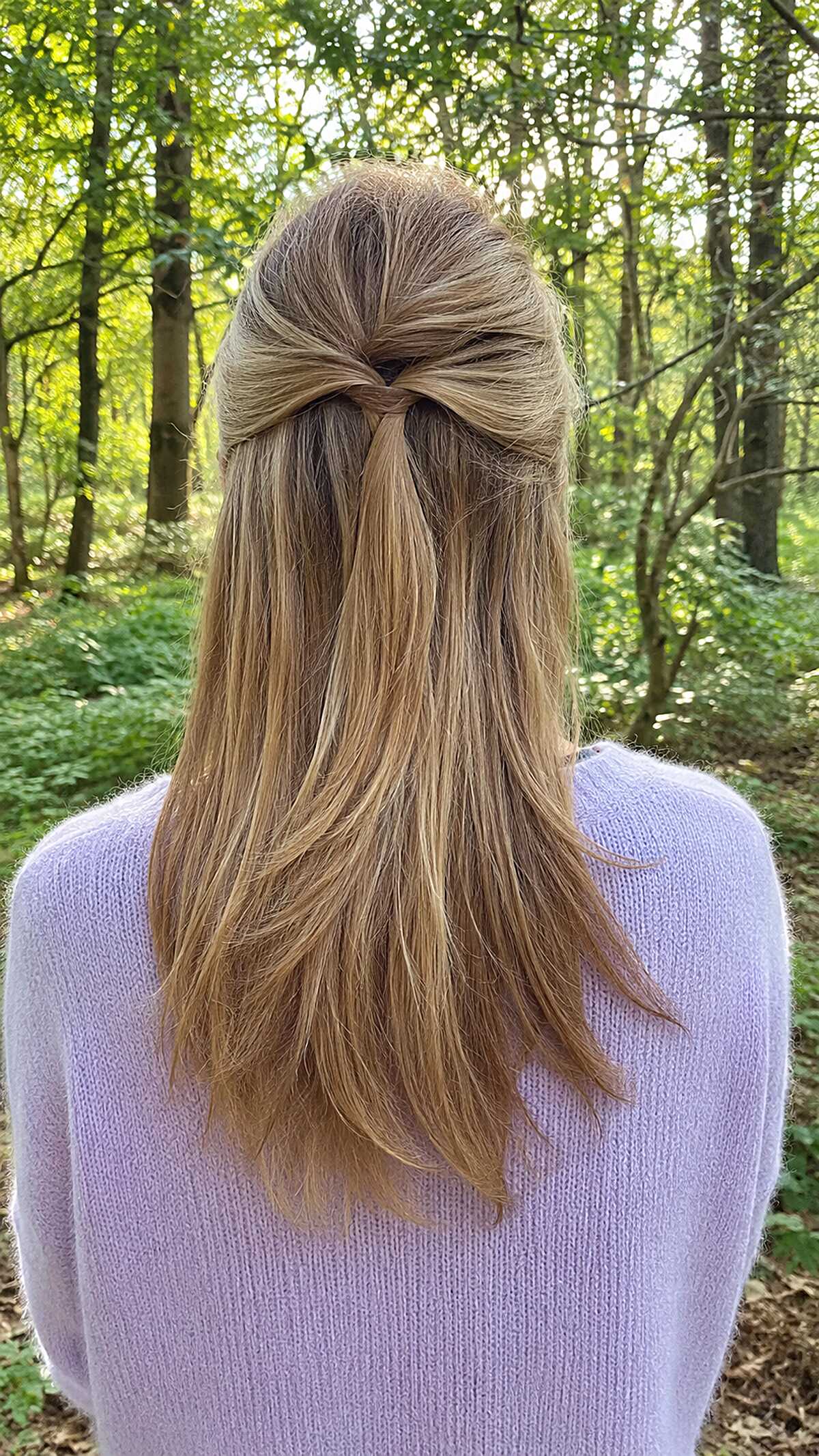 Fine straight blonde hair in a minimal half up style