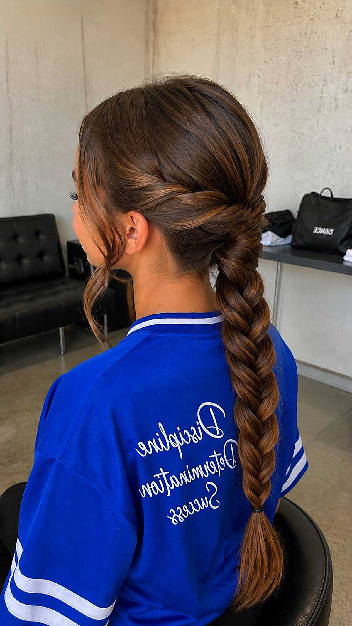 Girl with long twisted rope braid ponytail from behind