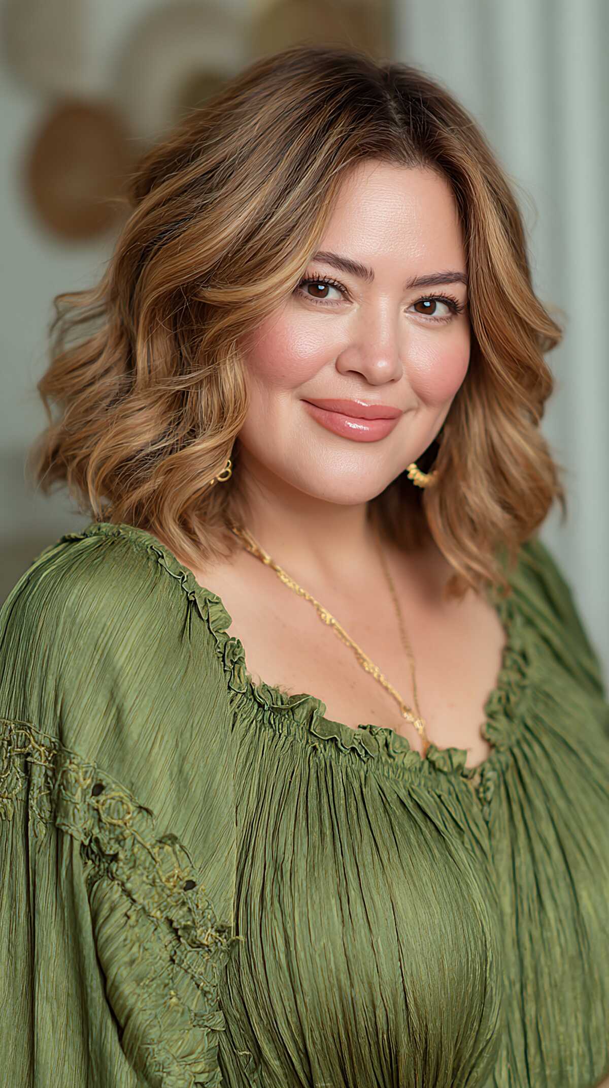 Warm caramel blonde wavy bob with full romantic volume