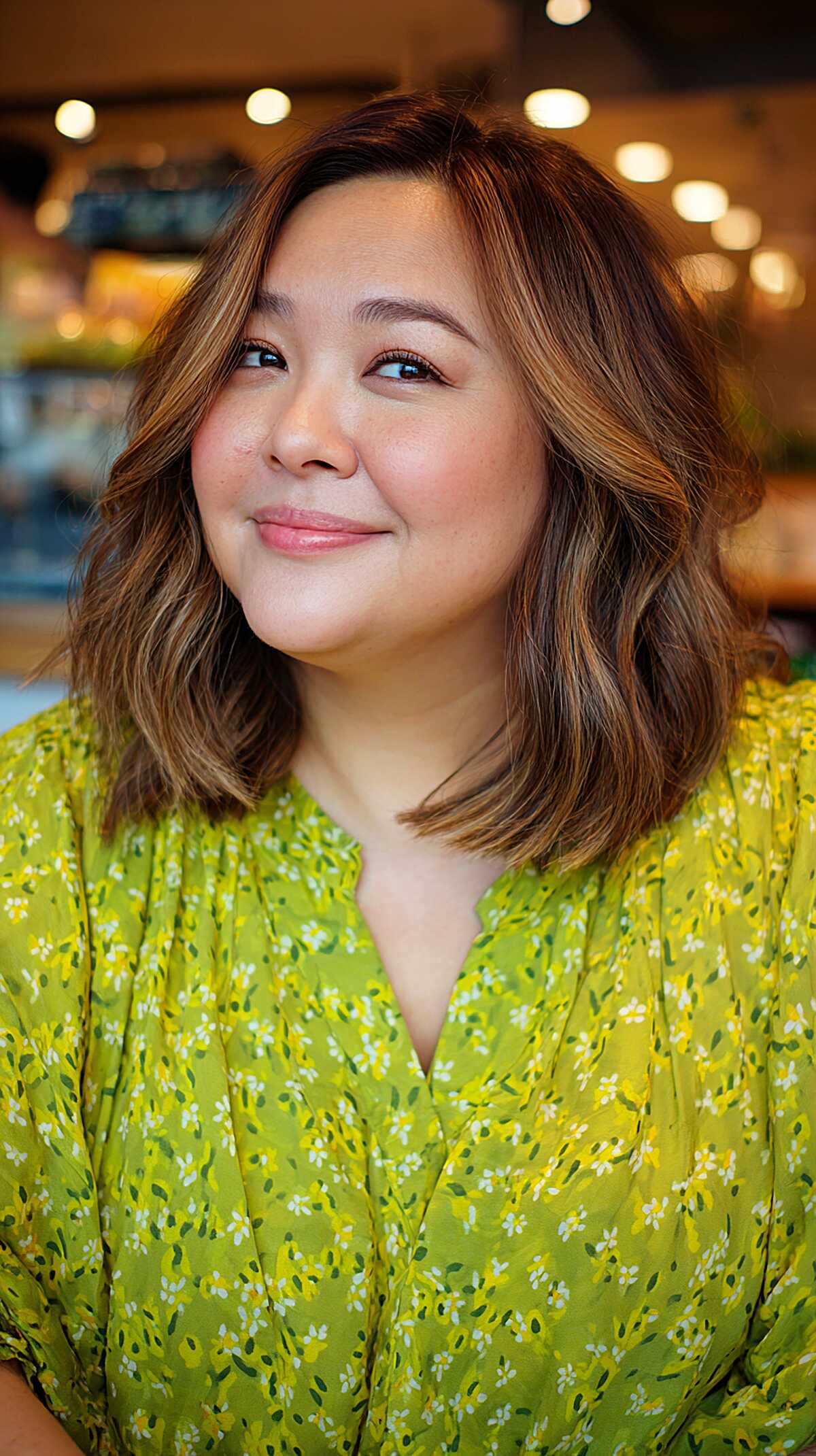 Warm chestnut wavy bob with soft caramel highlights