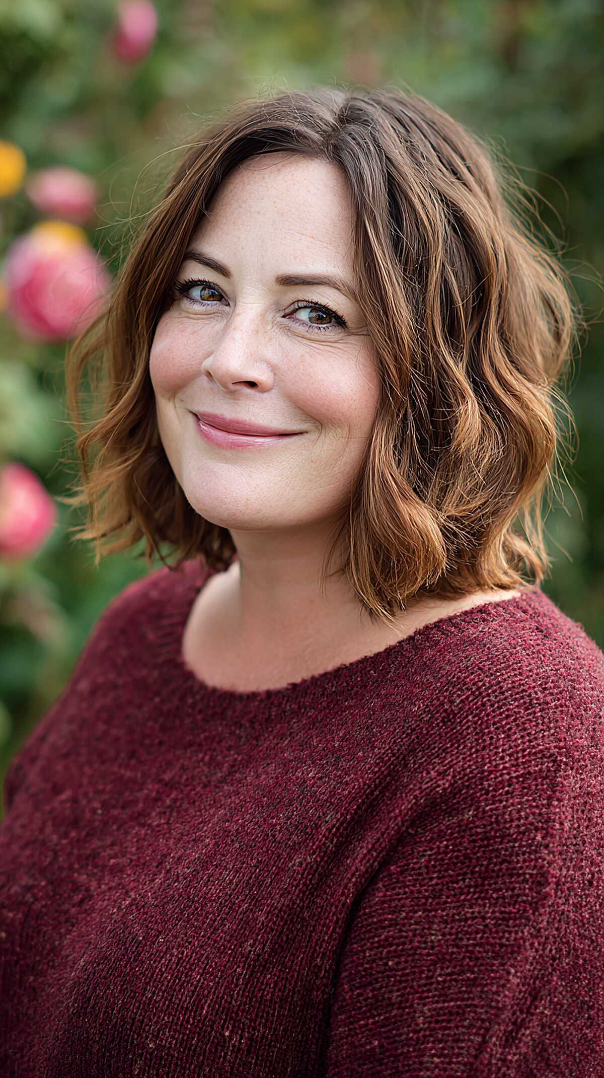 Wavy brunette bob with copper undertones in outdoor light