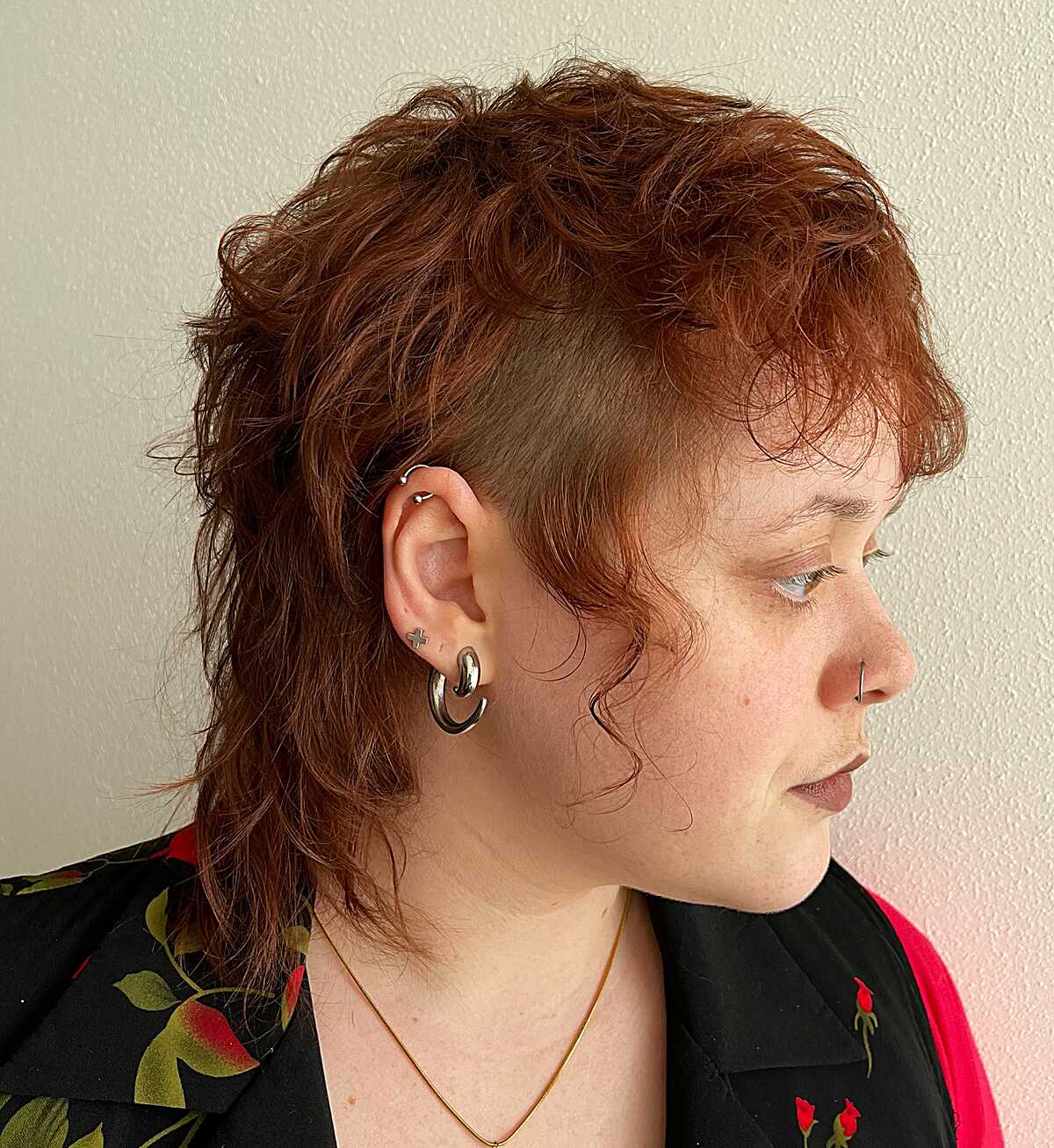 Copper wavy mullet with shaved temple and hoop earrings