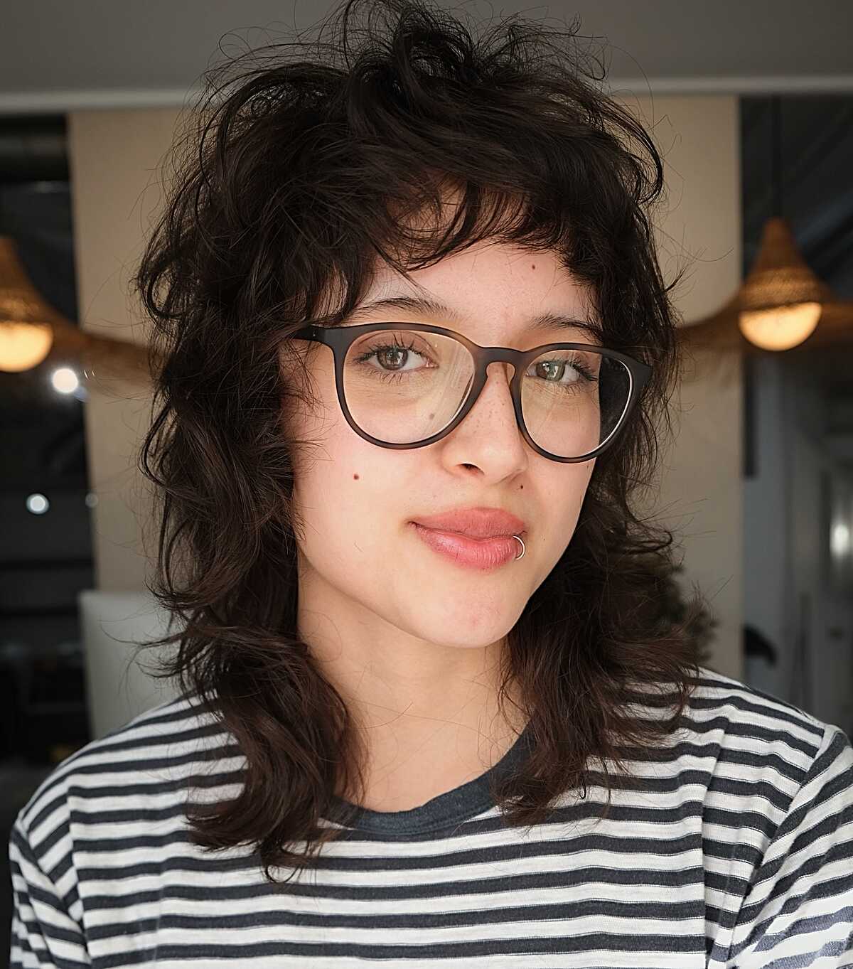 Dark wavy curly shag with soft curtain bangs
