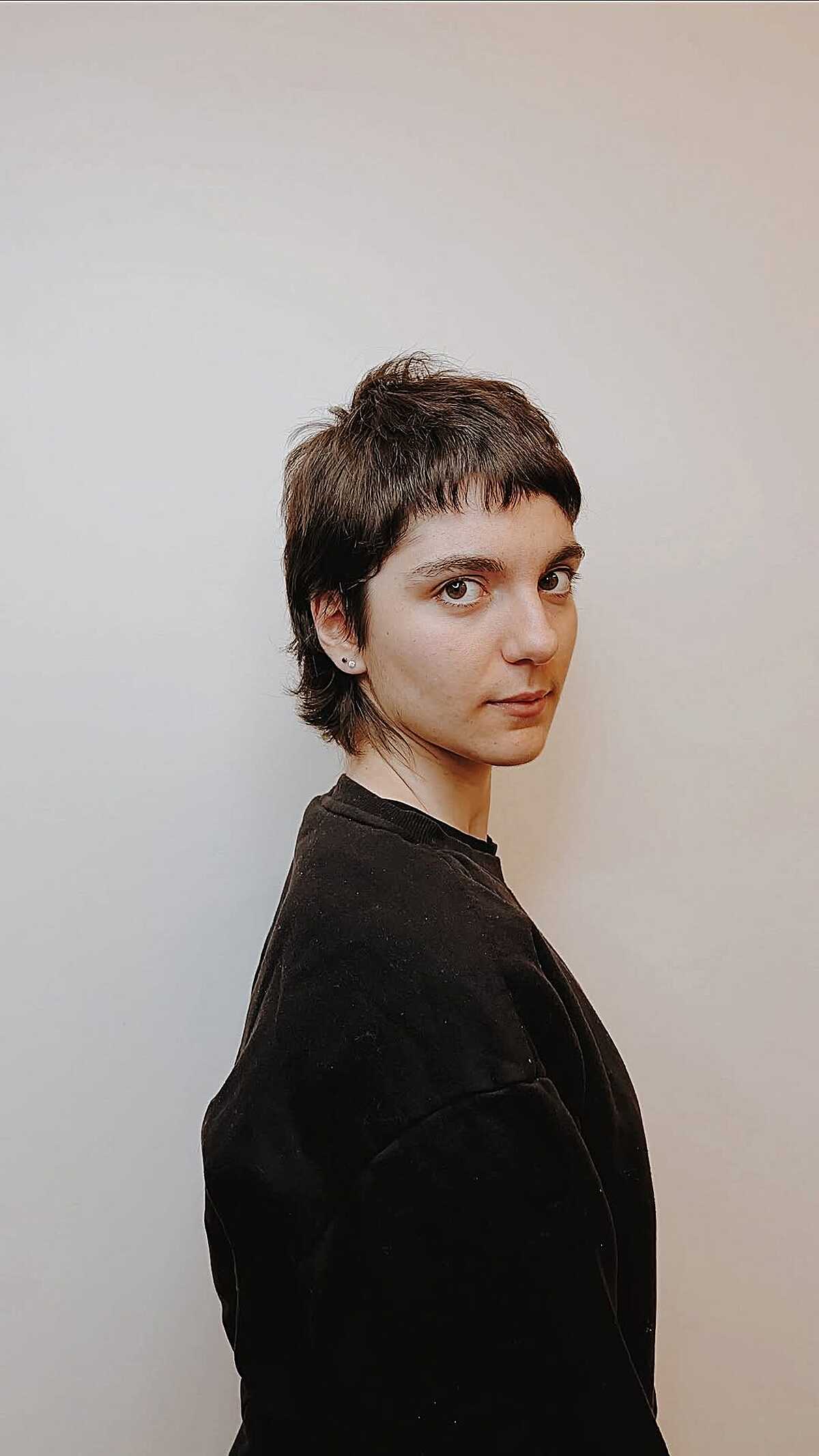 Short brown deconstructed pixie with piecey bangs