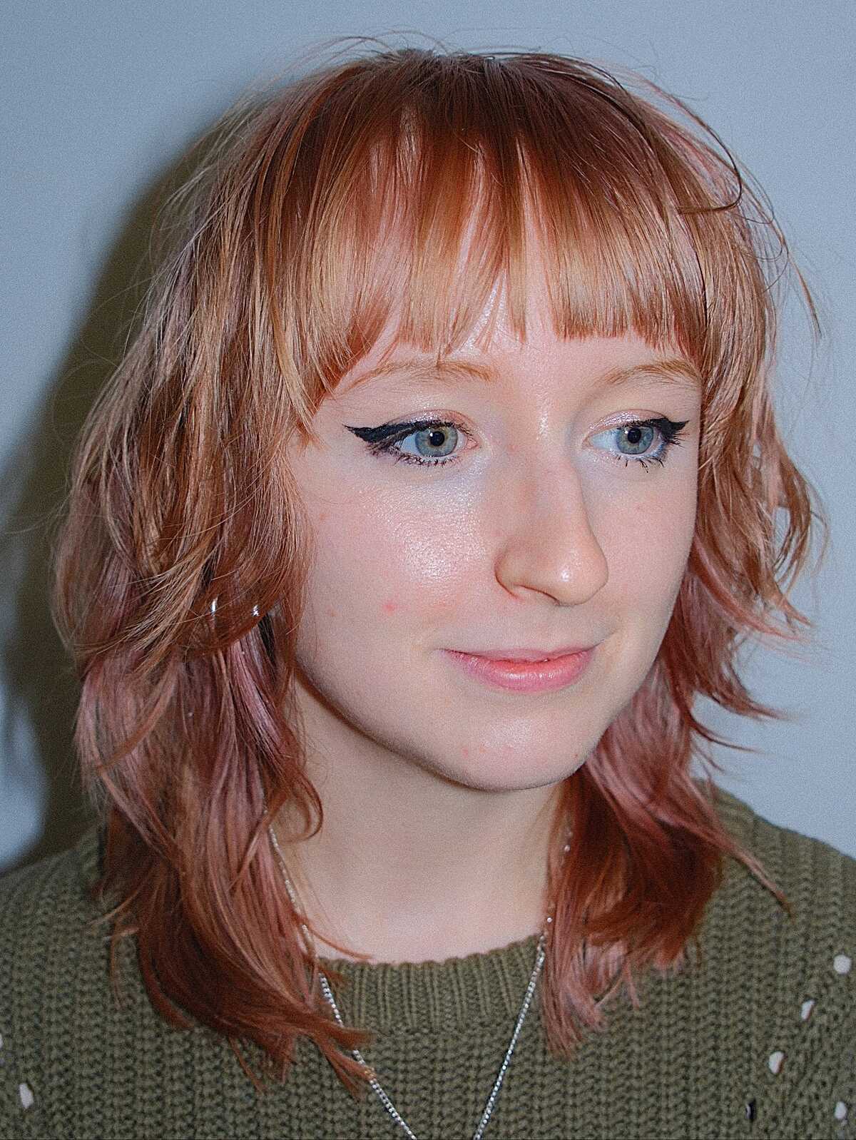 Faded pink-copper shag with short blunt bangs