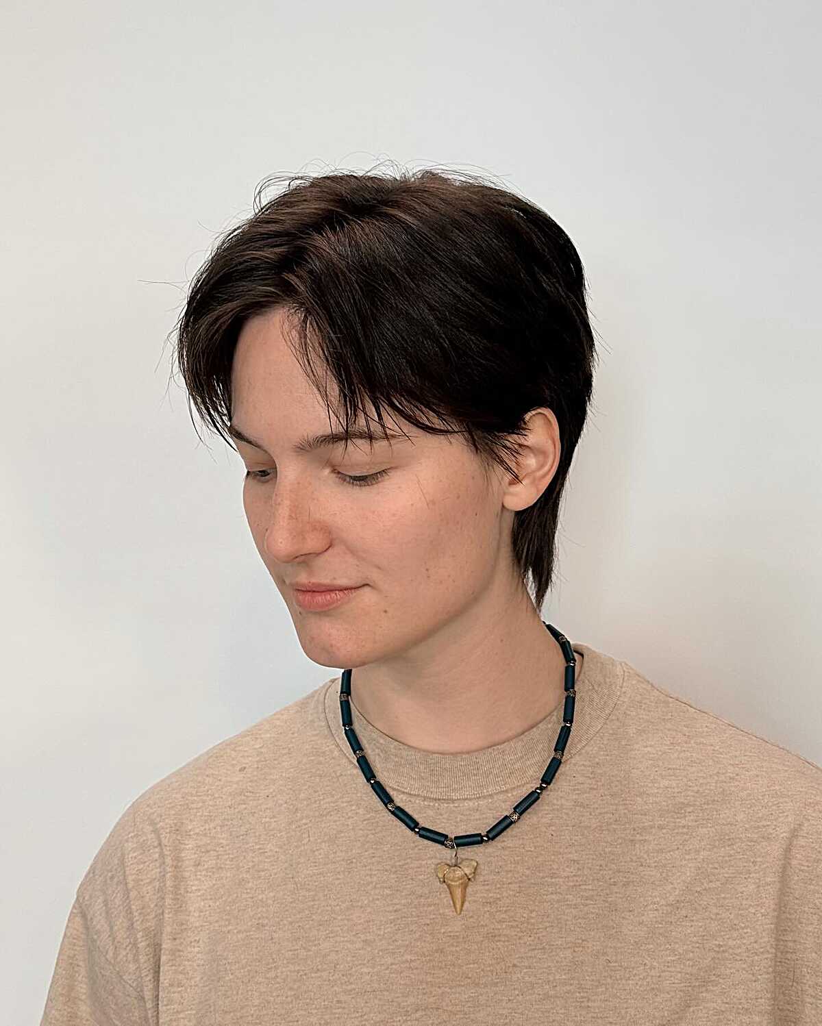 Dark brown soft pixie with long swept top and tapered sides