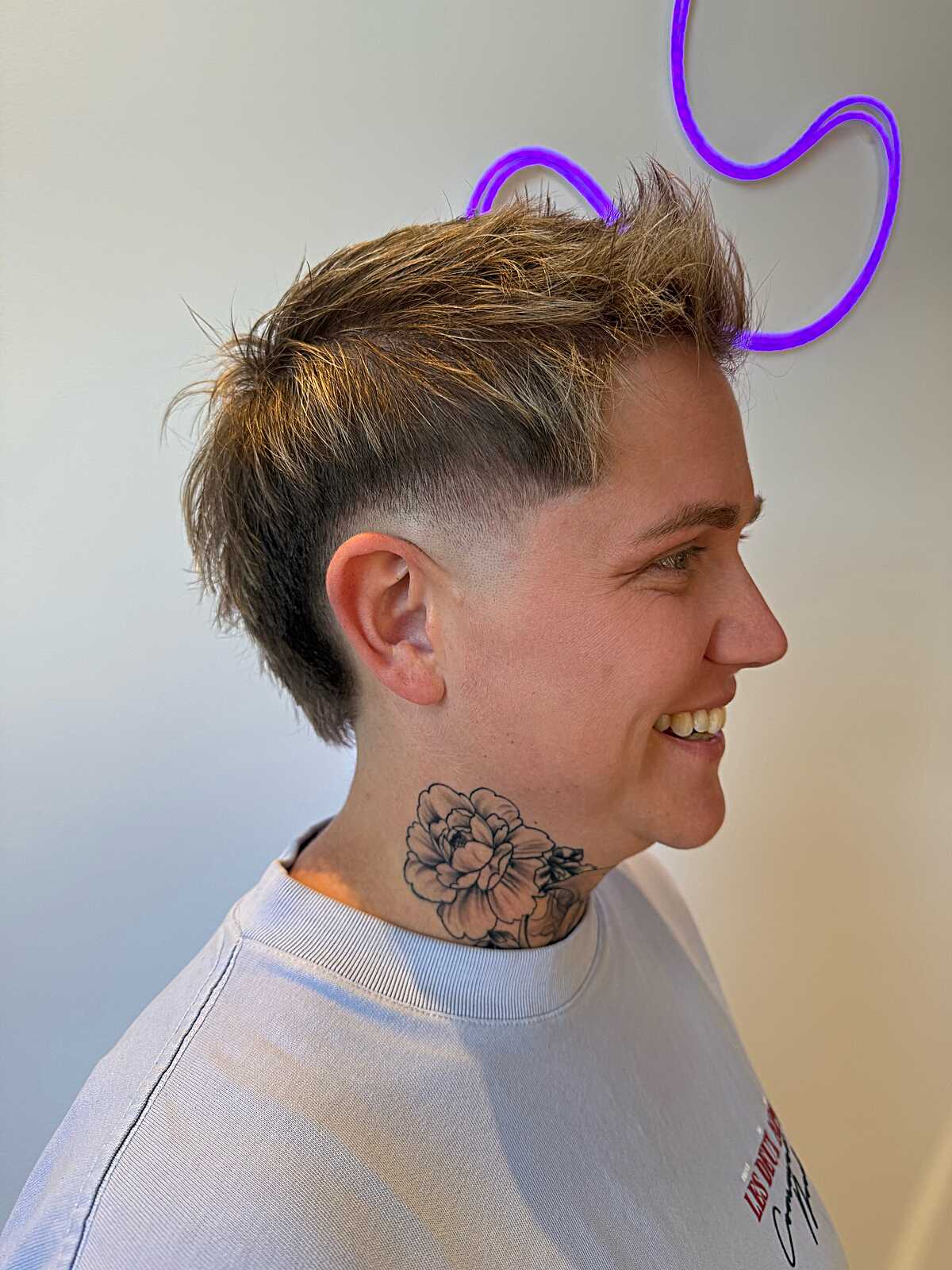 Blonde textured mohawk fade with forward-styled top