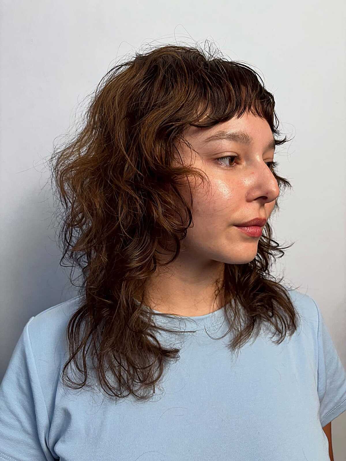 Wavy brown medium shag with short wispy bangs