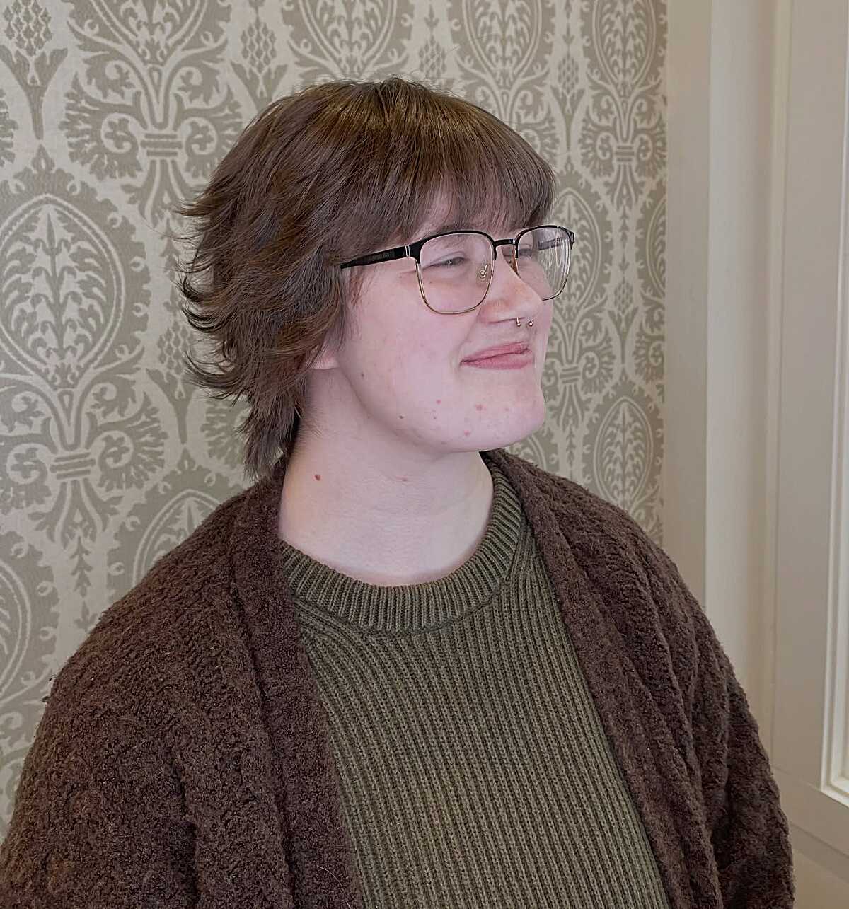 Warm brown layered shag with full bangs and glasses