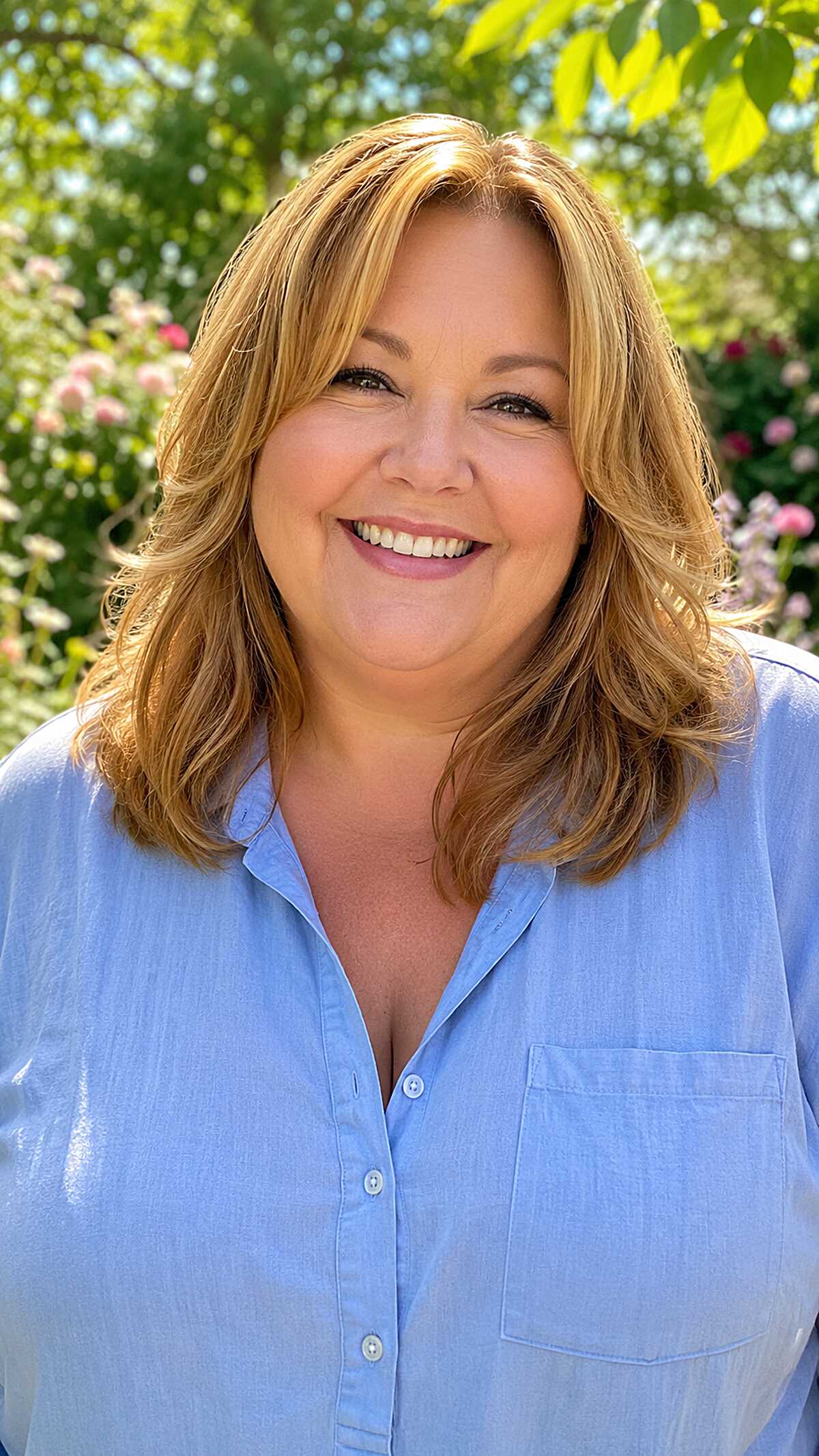 Warm honey blonde shoulder-length hair with layered volume