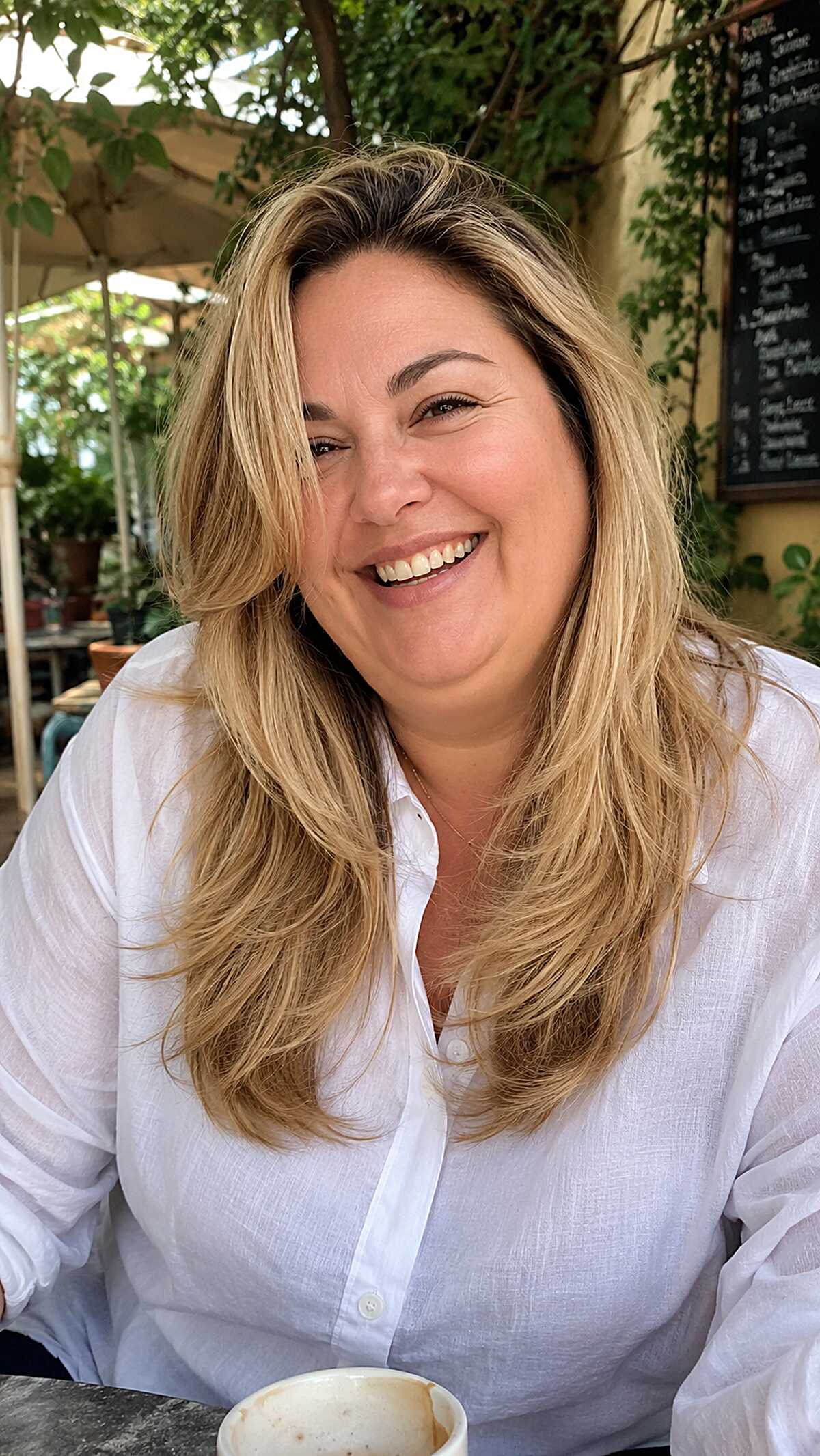 Long blonde layered hair with natural volume and movement