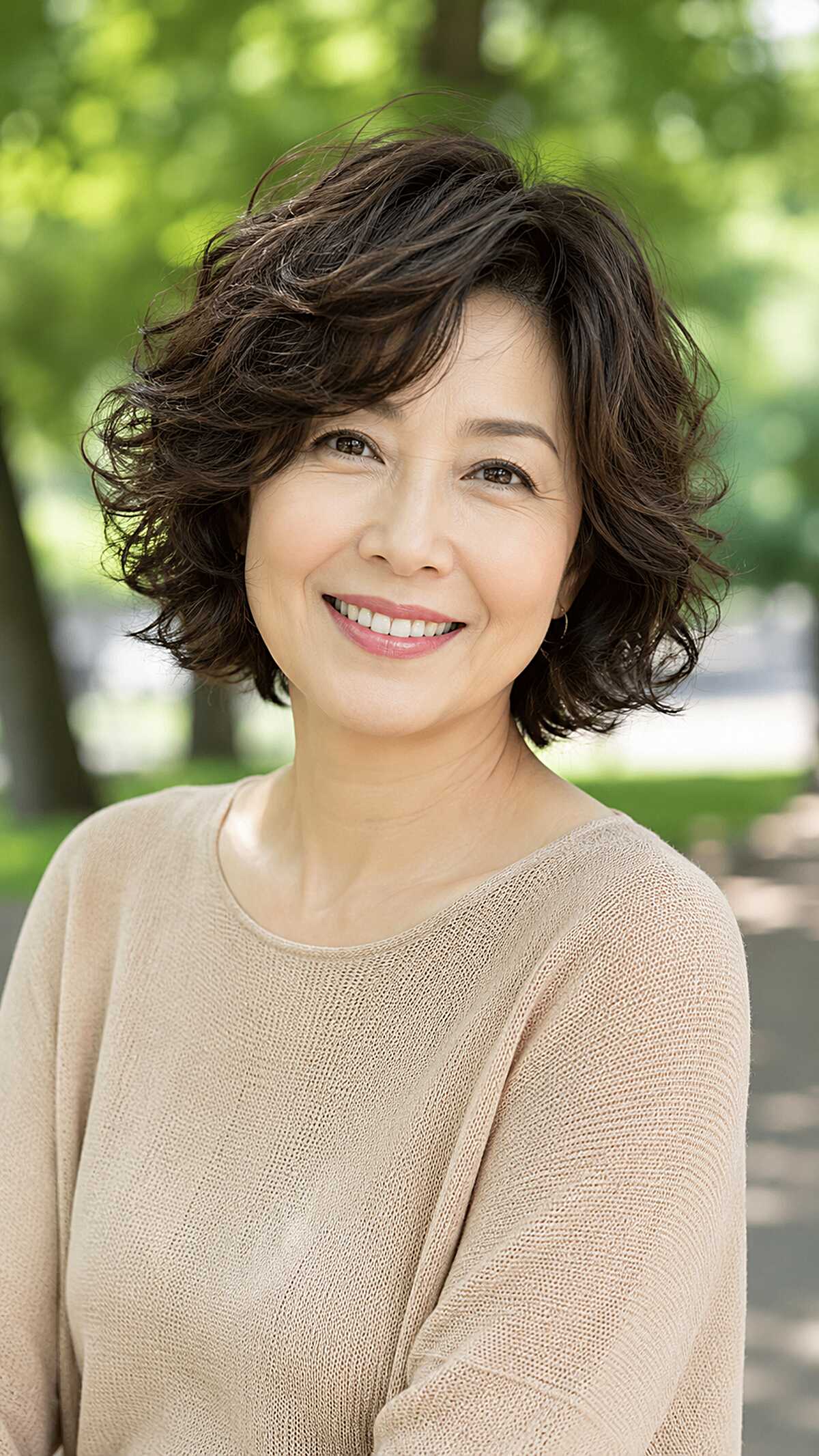 Voluminous dark brown permed bob with layered curls