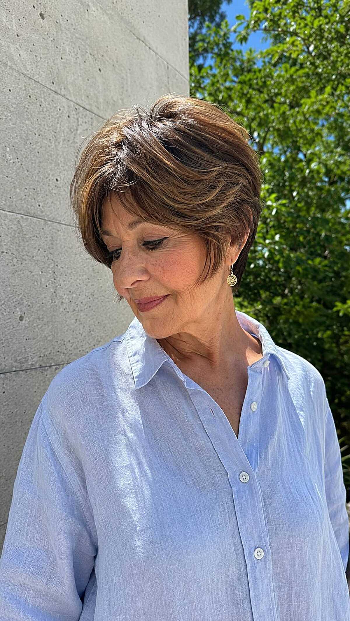 Short pixie with warm highlights and side-swept bangs