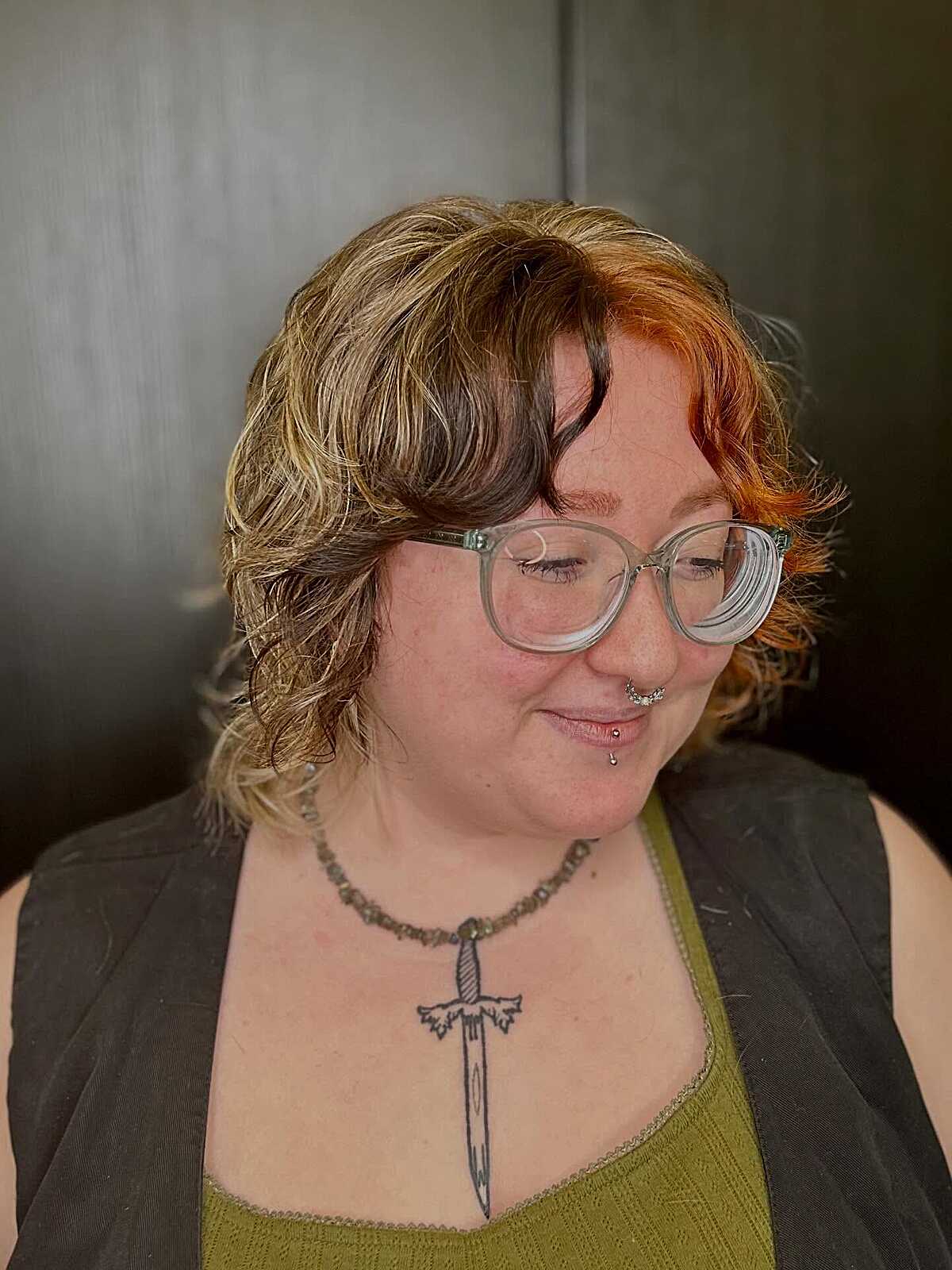 Short curly wolf cut with blonde, brown, and orange tones