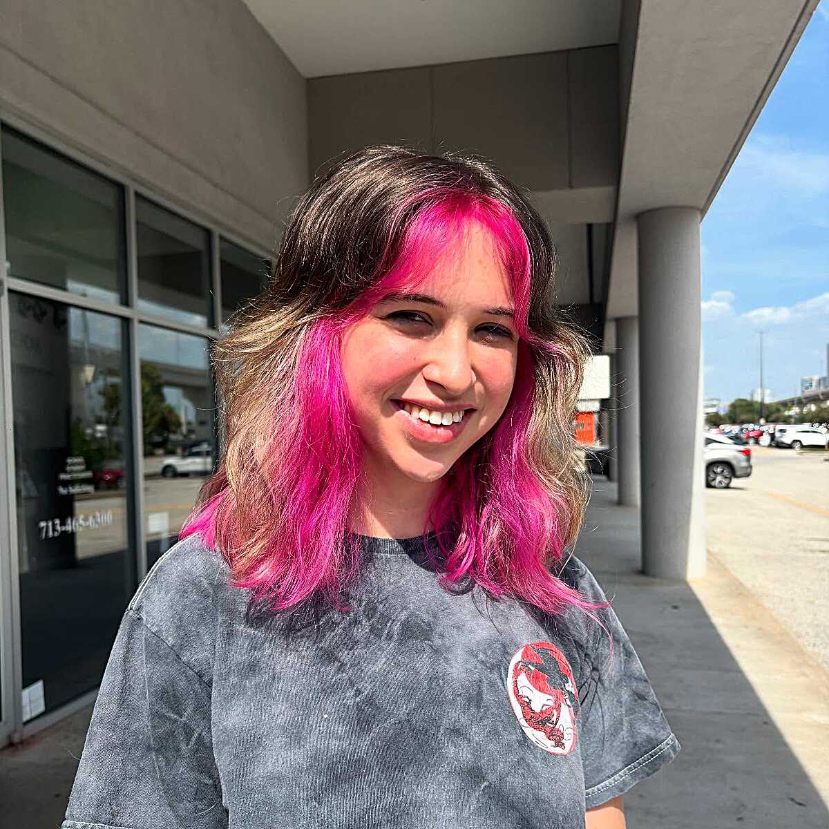 Shoulder-length wolf cut with hot pink color streaks