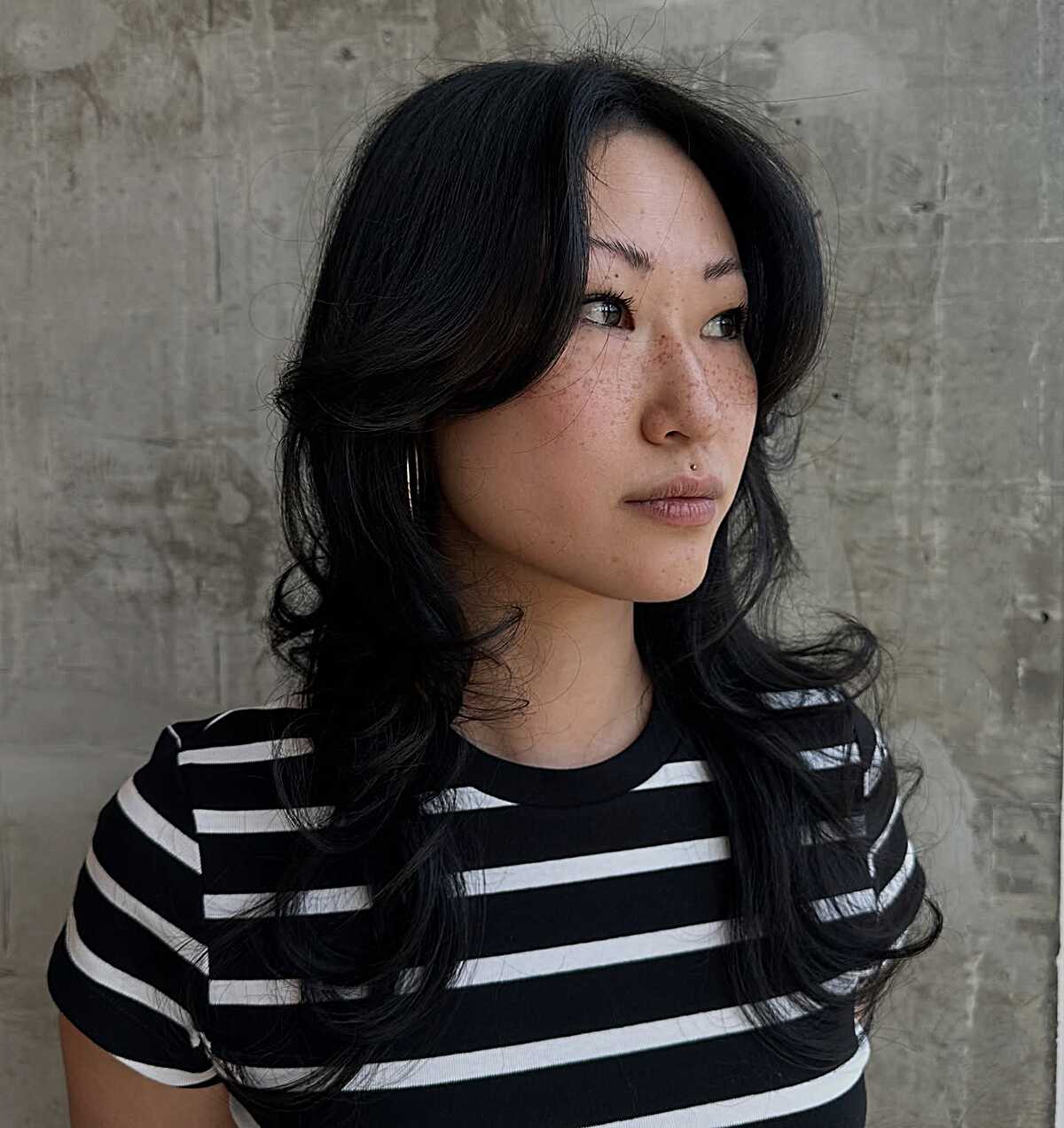 Long jet black wavy wolf cut with center-part bangs
