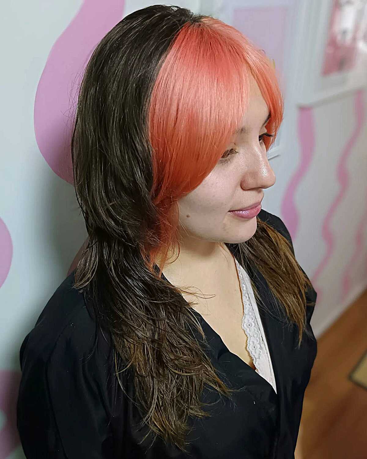 Black wolf cut with peach orange curtain bangs
