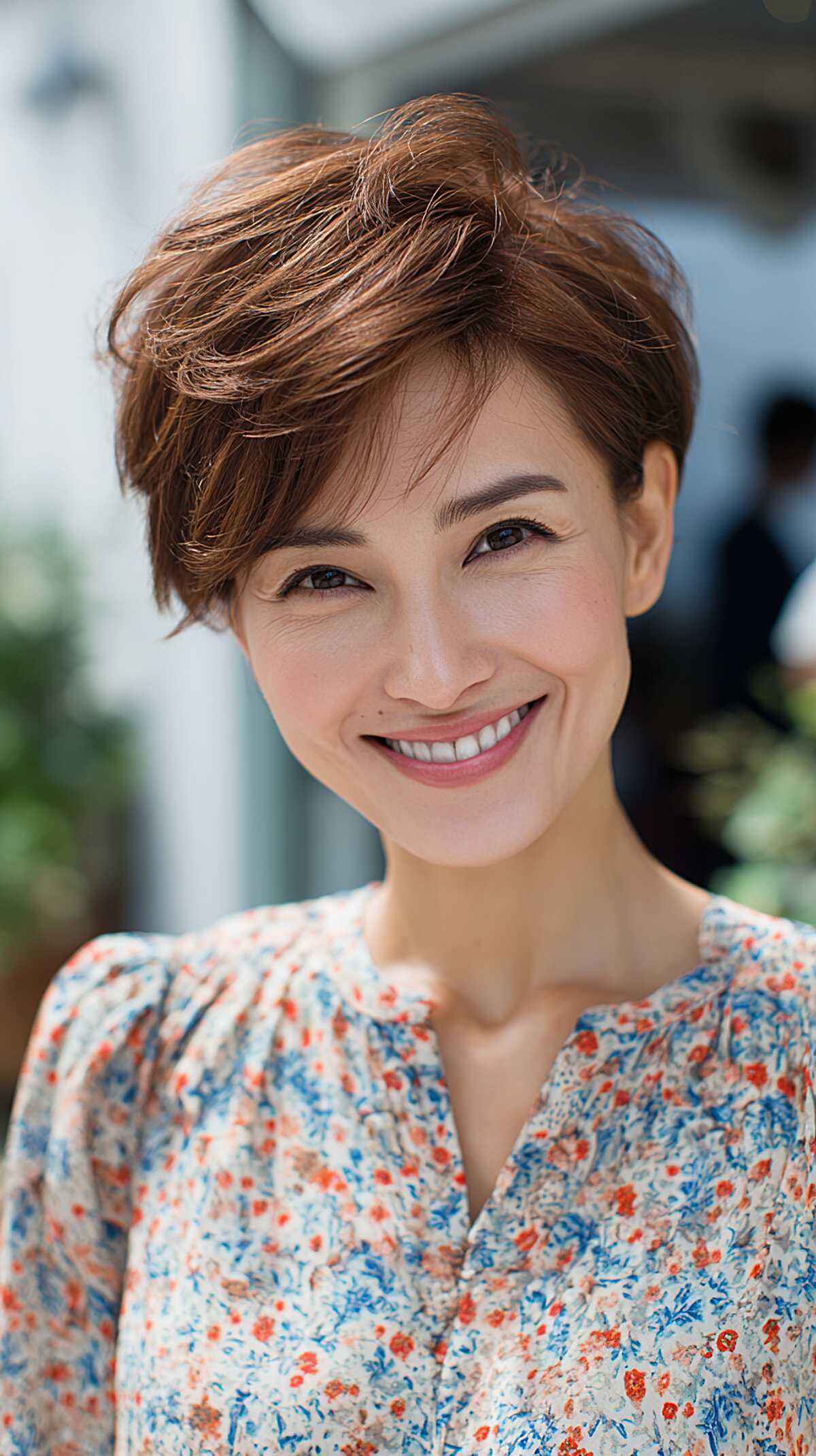 Feathered auburn pixie with volume at the crown and soft sides