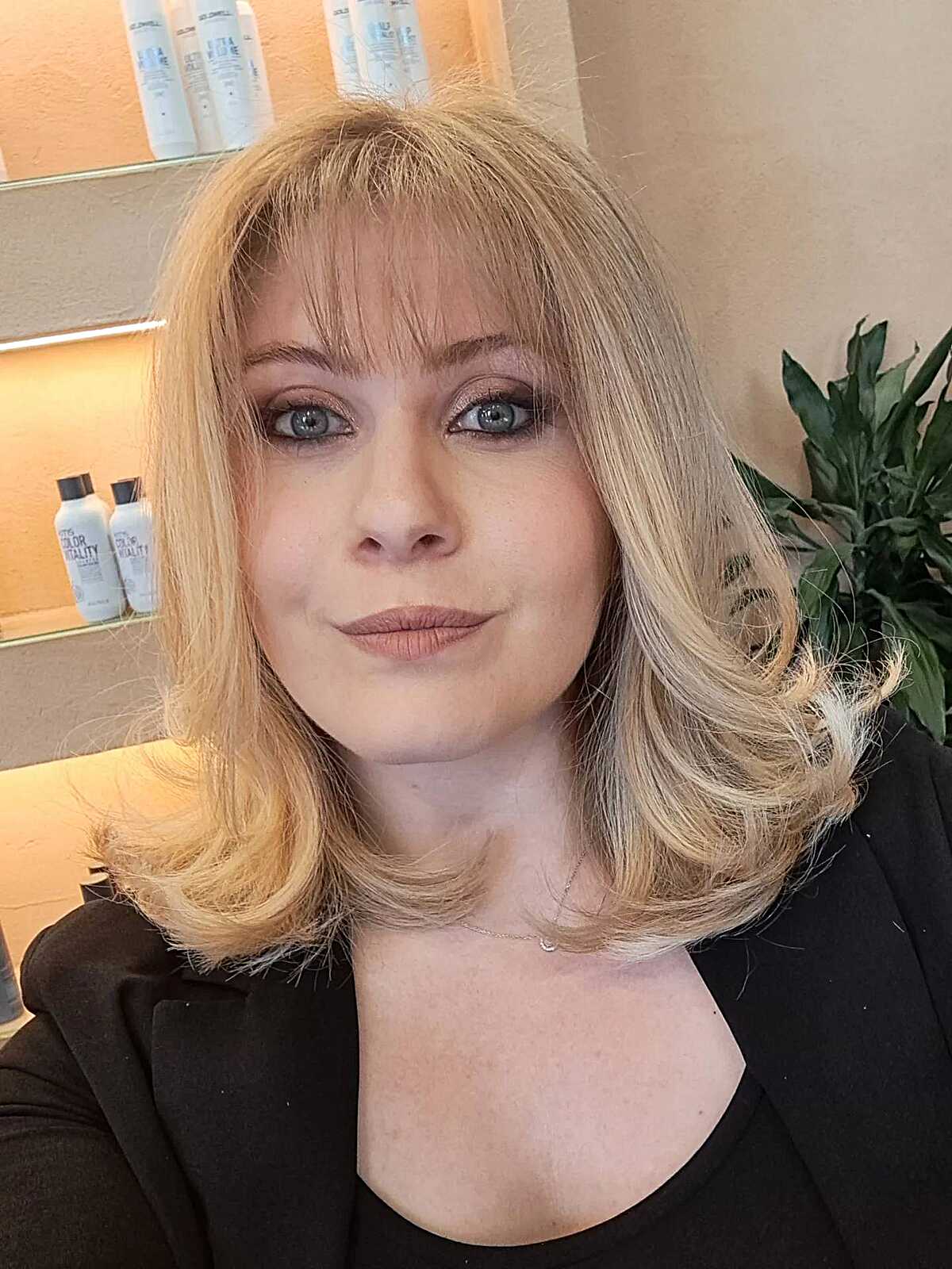Medium blonde bob with full bangs and flipped ends