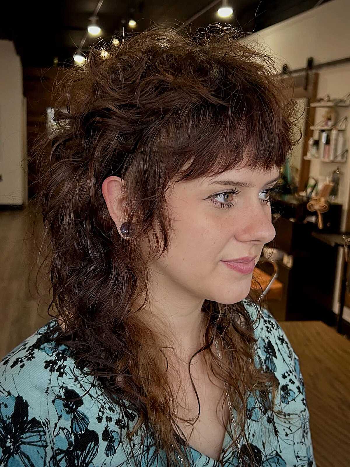 Curly brunette shag mullet with textured bangs