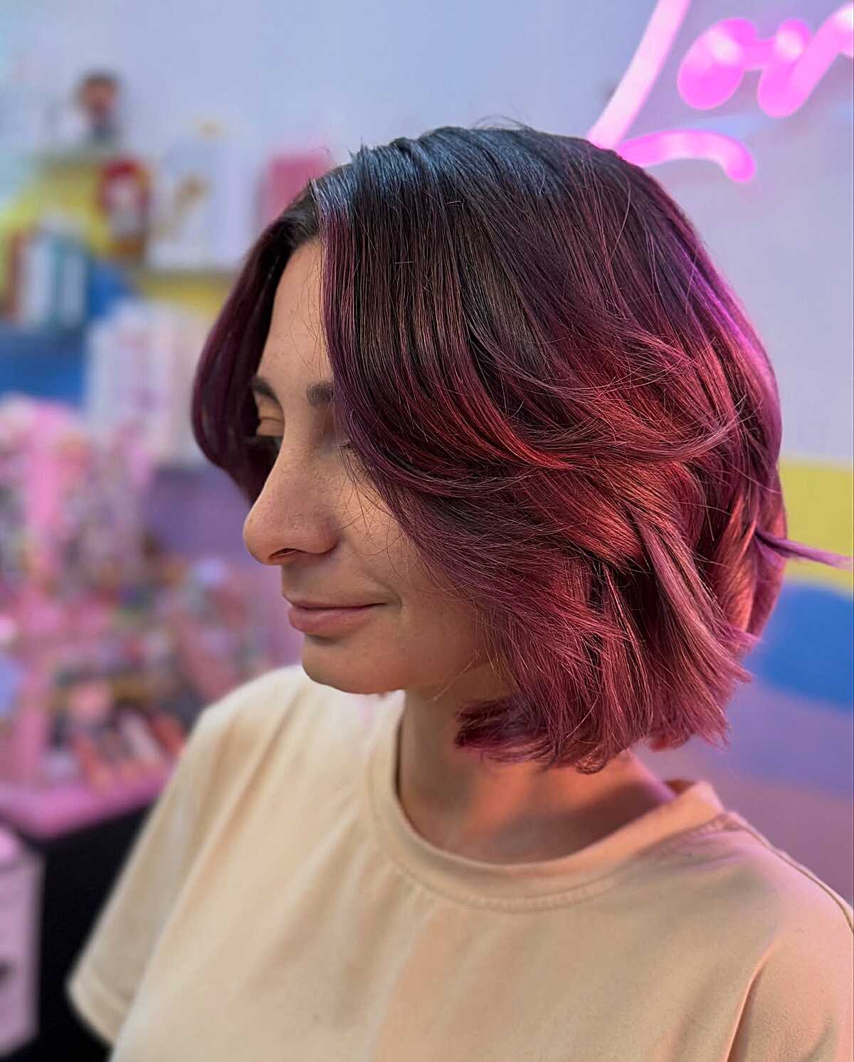 Short dark cherry red bob with flipped layered ends