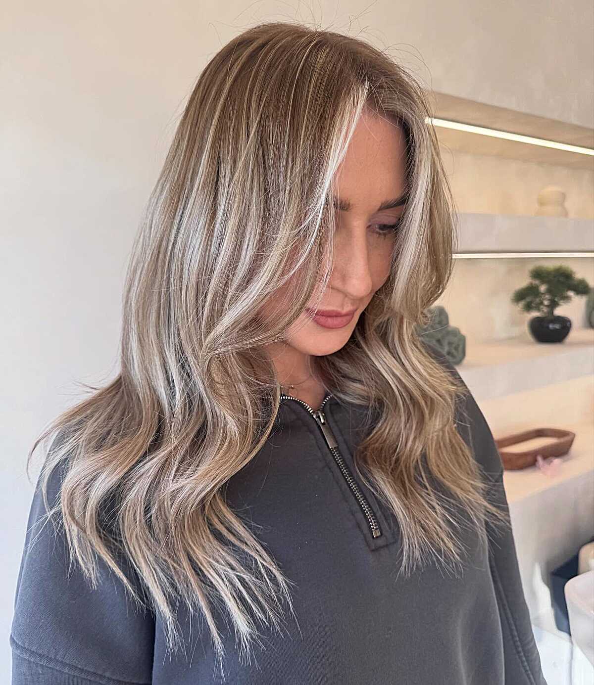 Long ash blonde hair with bright face-framing highlights