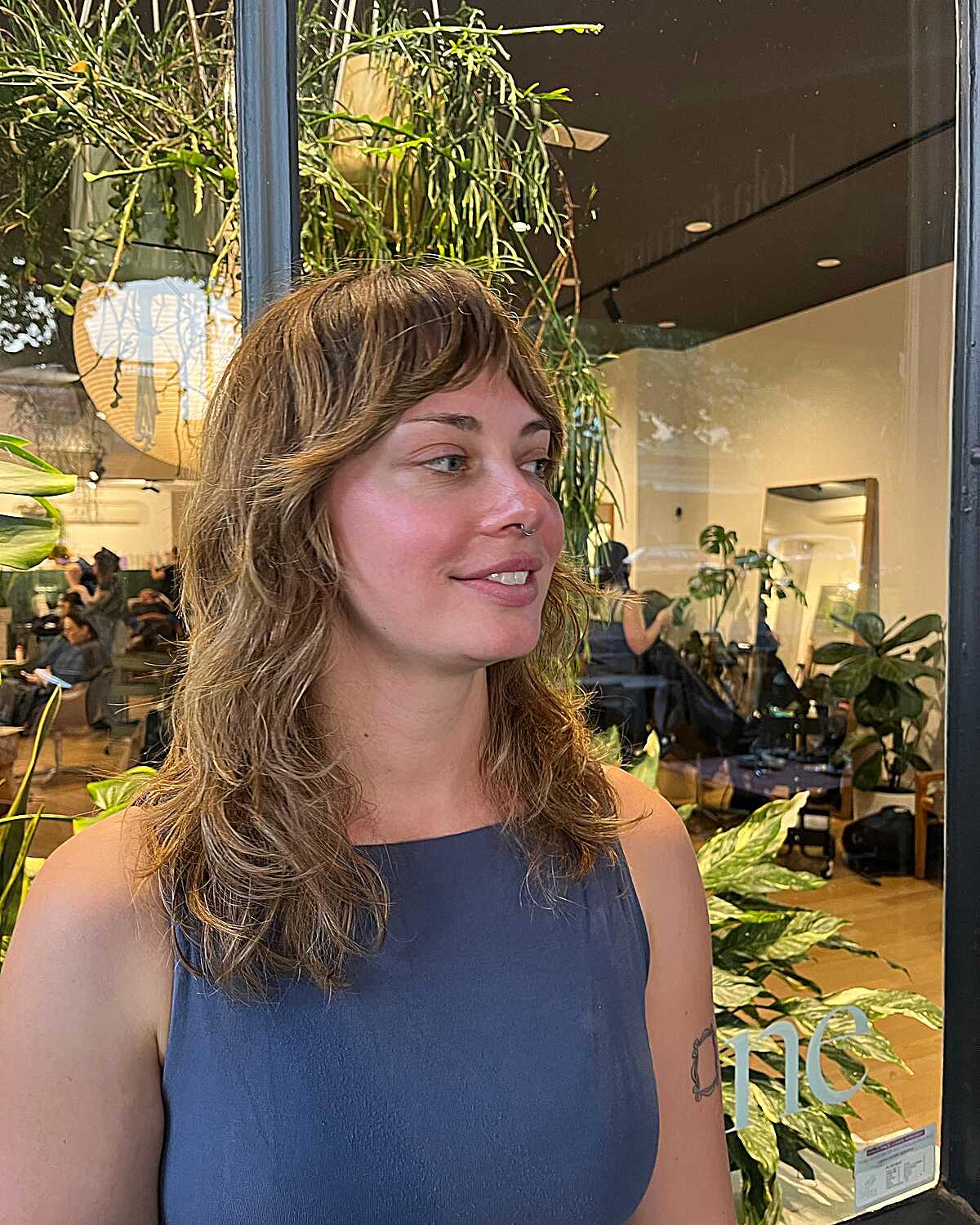 Medium shag haircut with bangs and warm highlighted ends