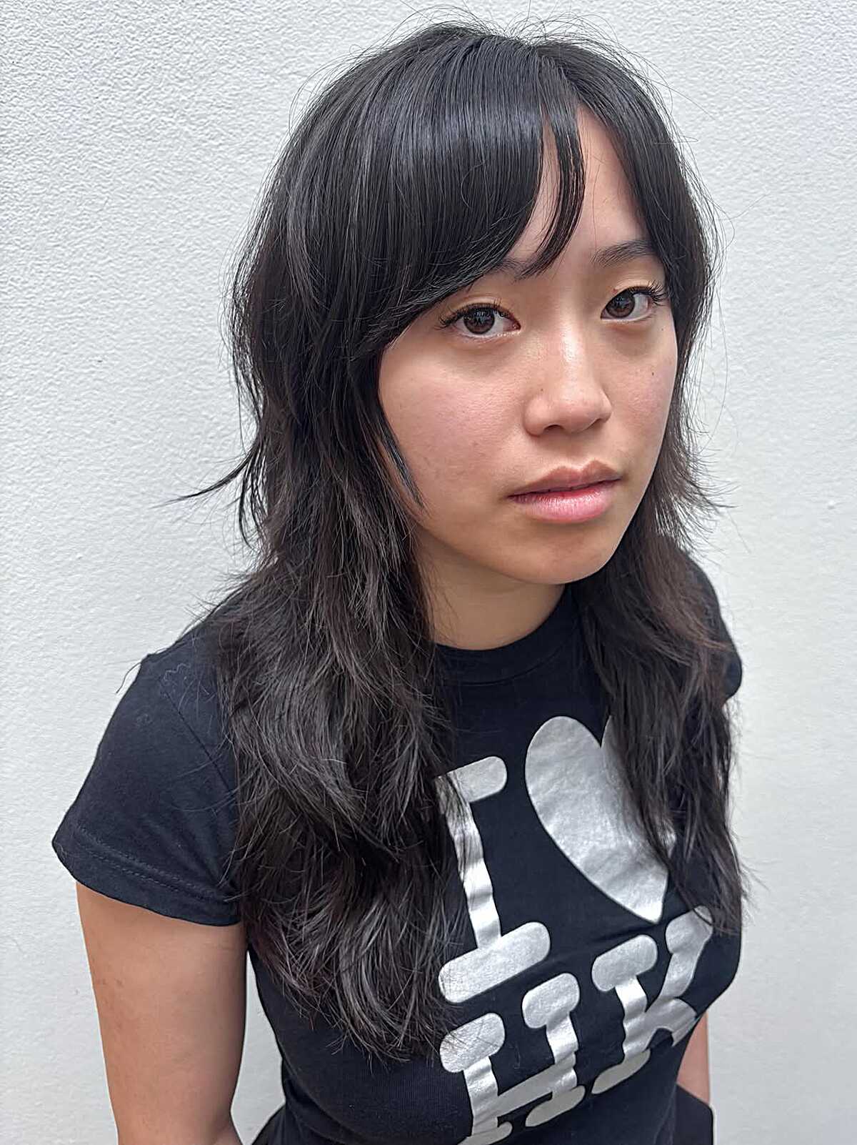 Long black wavy mullet with wispy curtain bangs