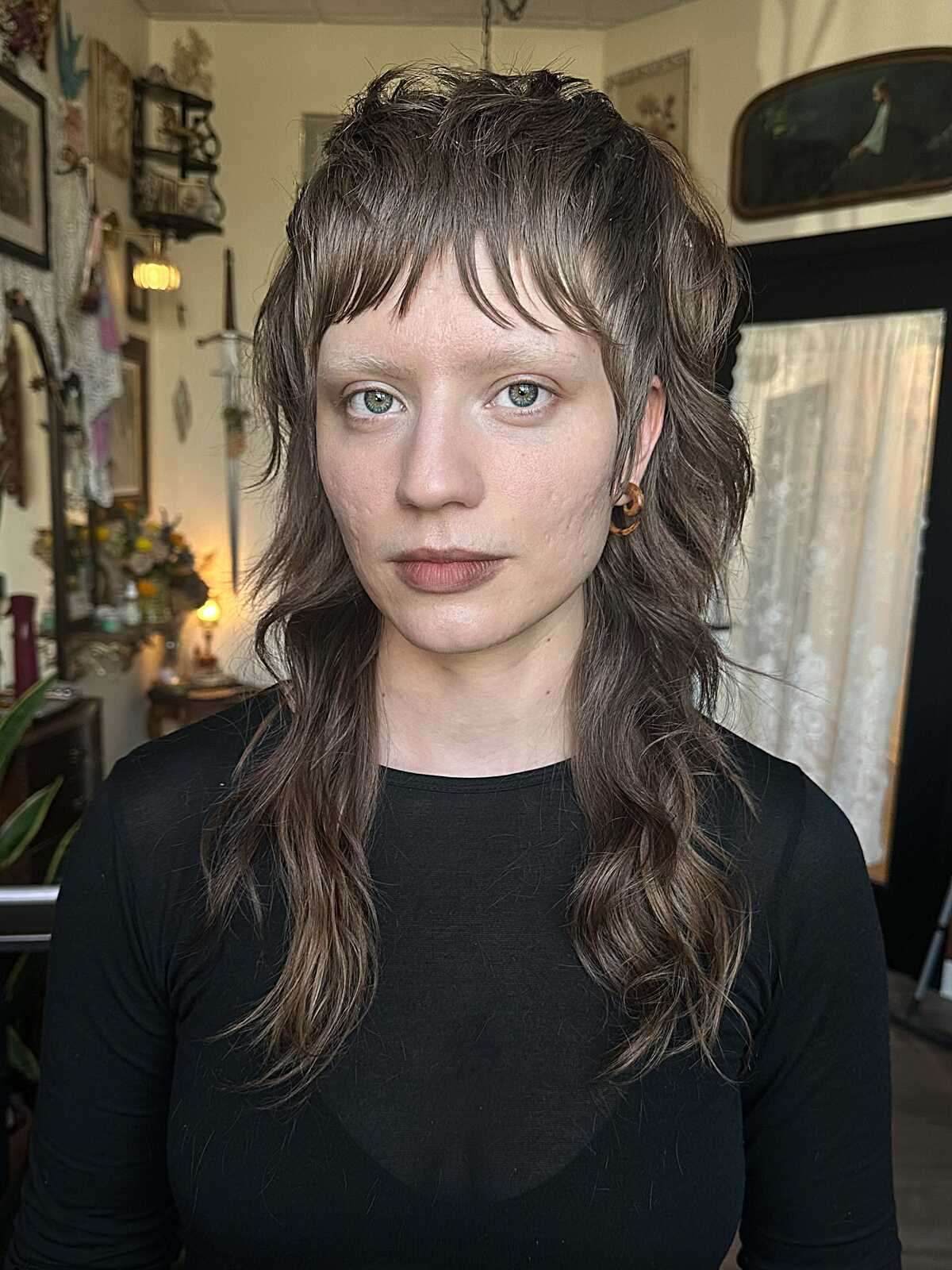 Shaggy light brown mullet with micro bangs and waves