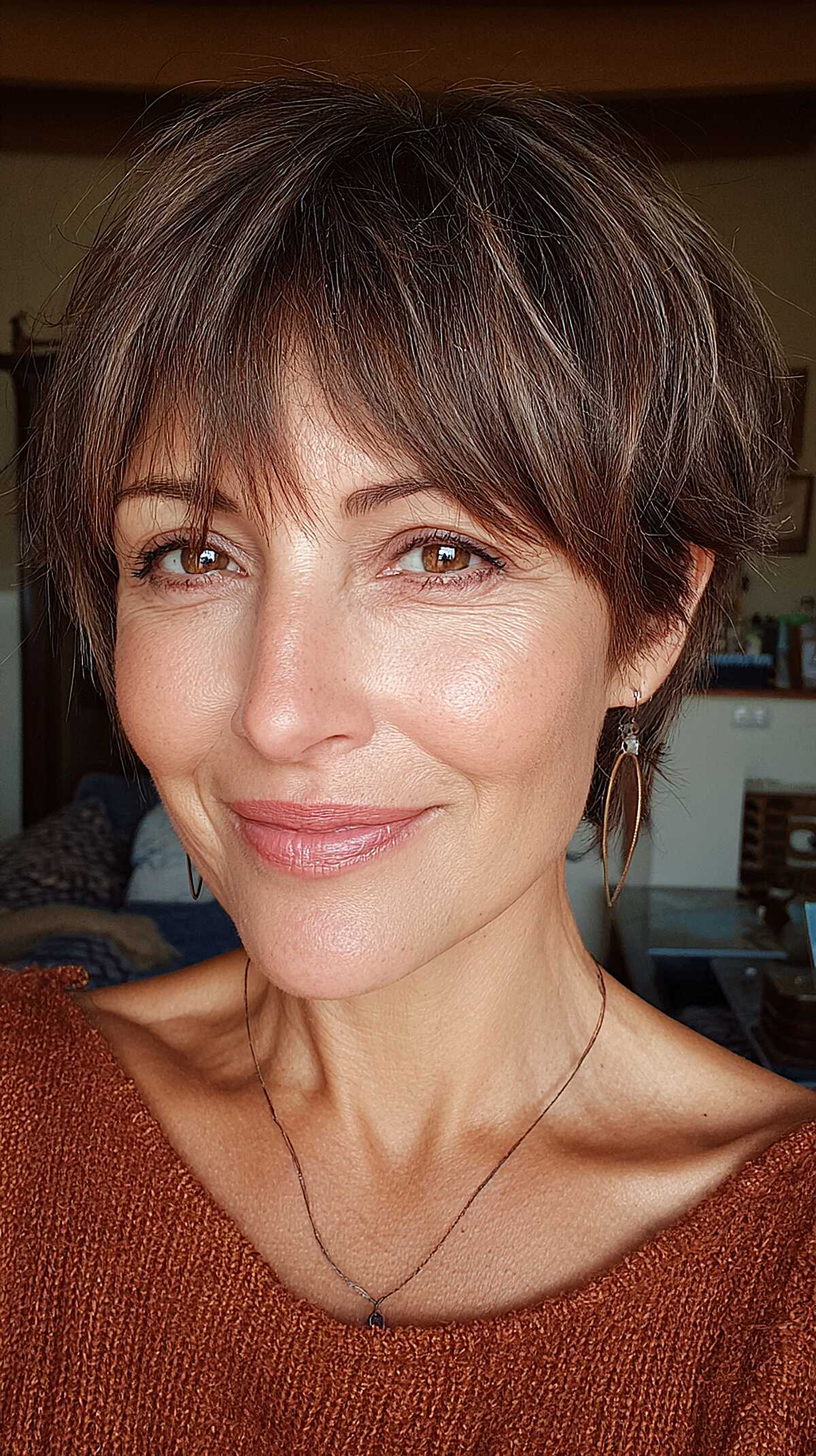 Soft brunette pixie-length mixie with wispy layered bangs
