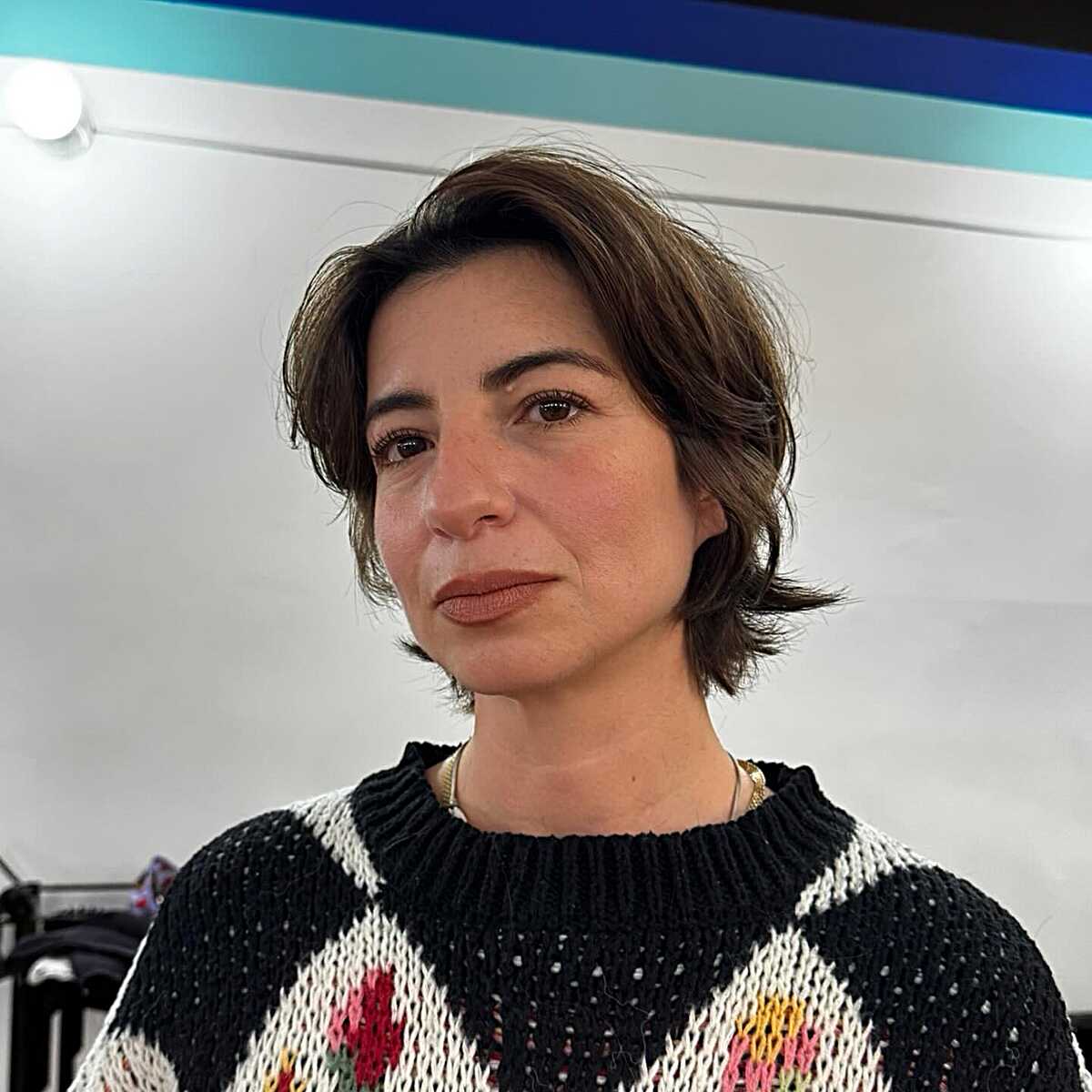 Short brunette layers with soft flippy ends and side part