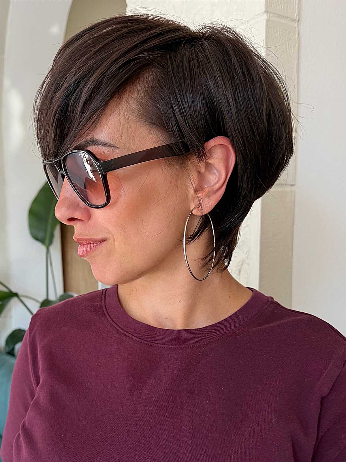 Short dark brown pixie with long sweeping side bangs