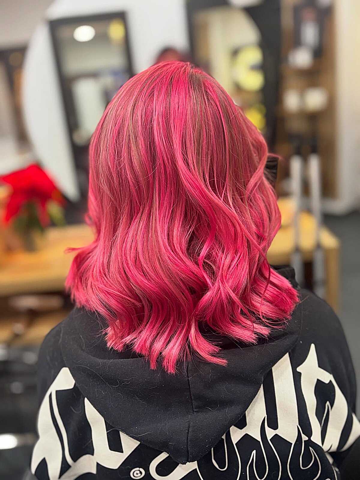 Bright hot coral pink shoulder-length wavy bob