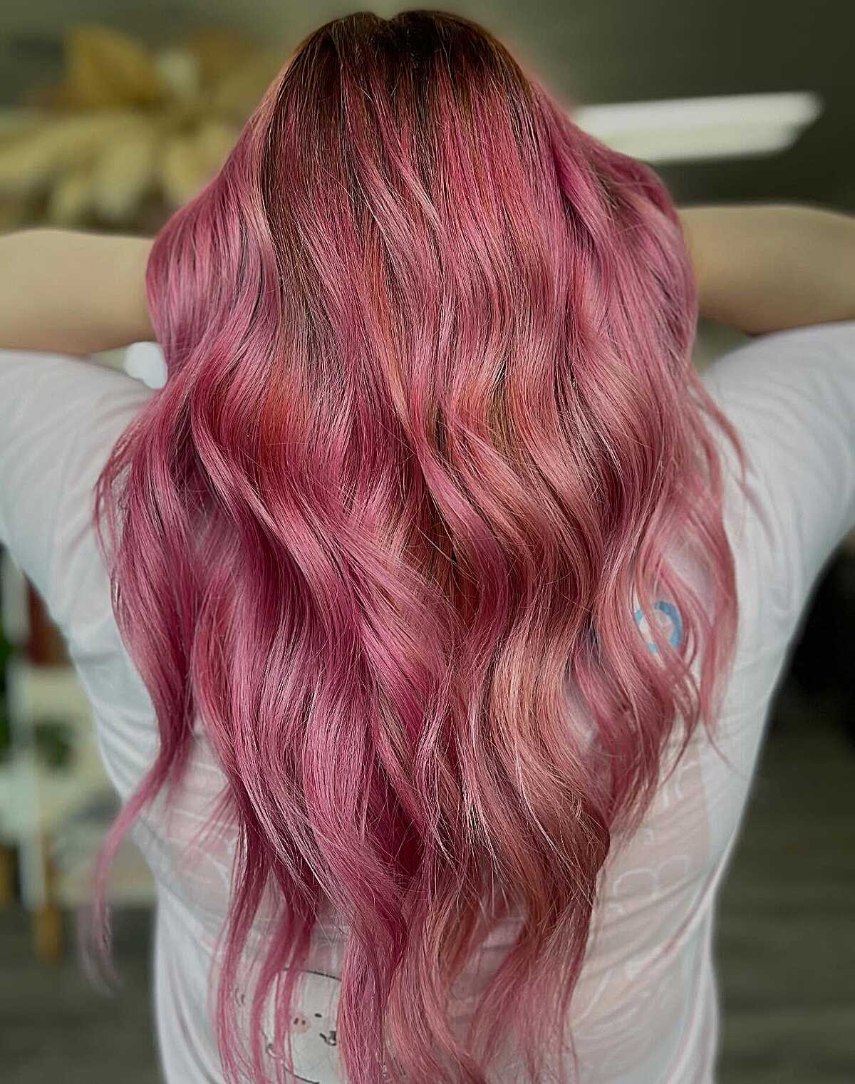 Long warm rose pink waves with dark root dimension
