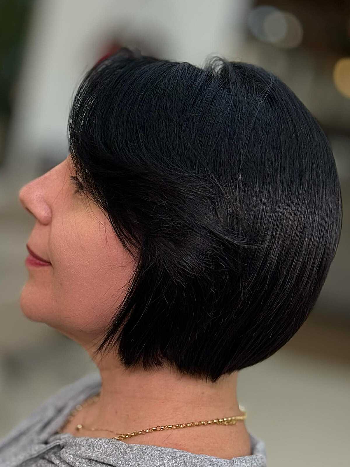 Jet black rounded bob with side-swept layers