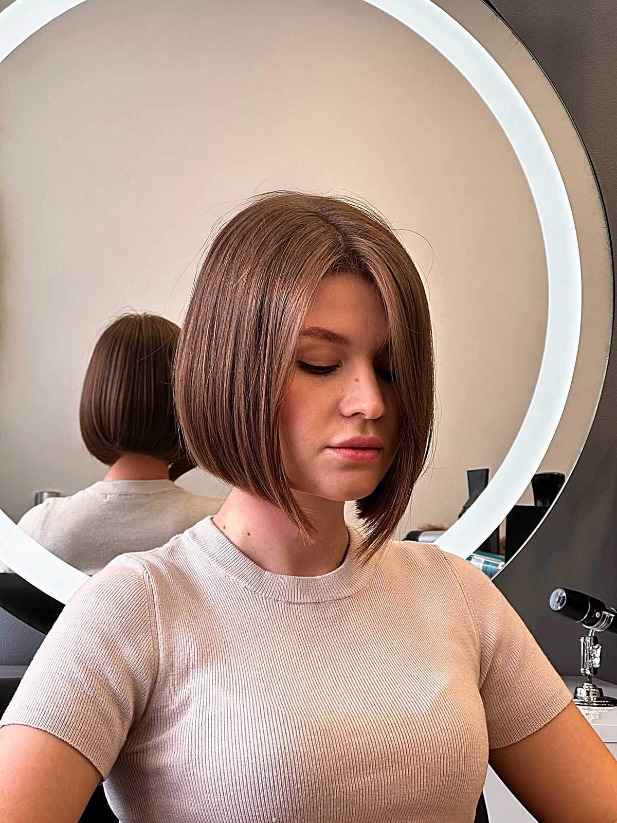 Angled bronde bob with smooth blowout just below chin