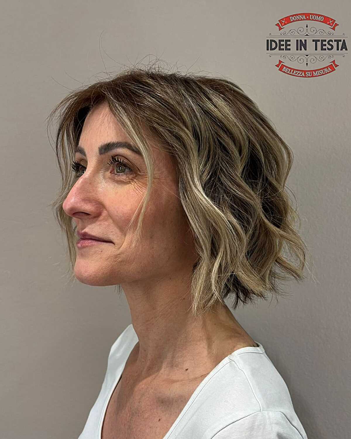 Wavy bronde bob with sun-kissed highlights at jawline